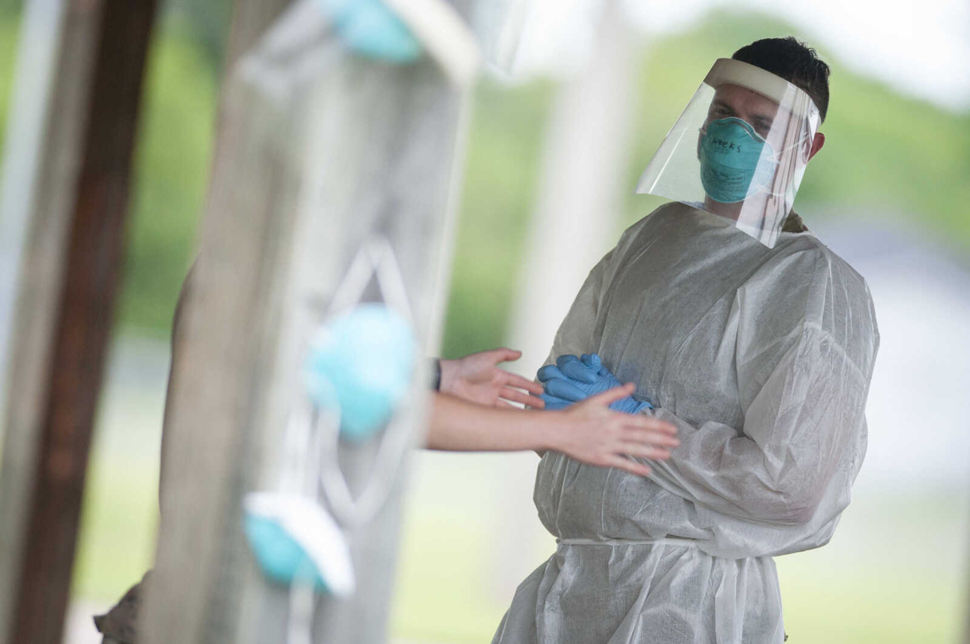 Zachary Weeks, a sergeant with the Missouri Army National Guard, converses while in personal protective equipment during free COVID-19 testing Friday, June 5, 2020, at Arena Park in Cape Girardeau. The drive-up testing event was scheduled for 7 a.m. to 7 p.m.