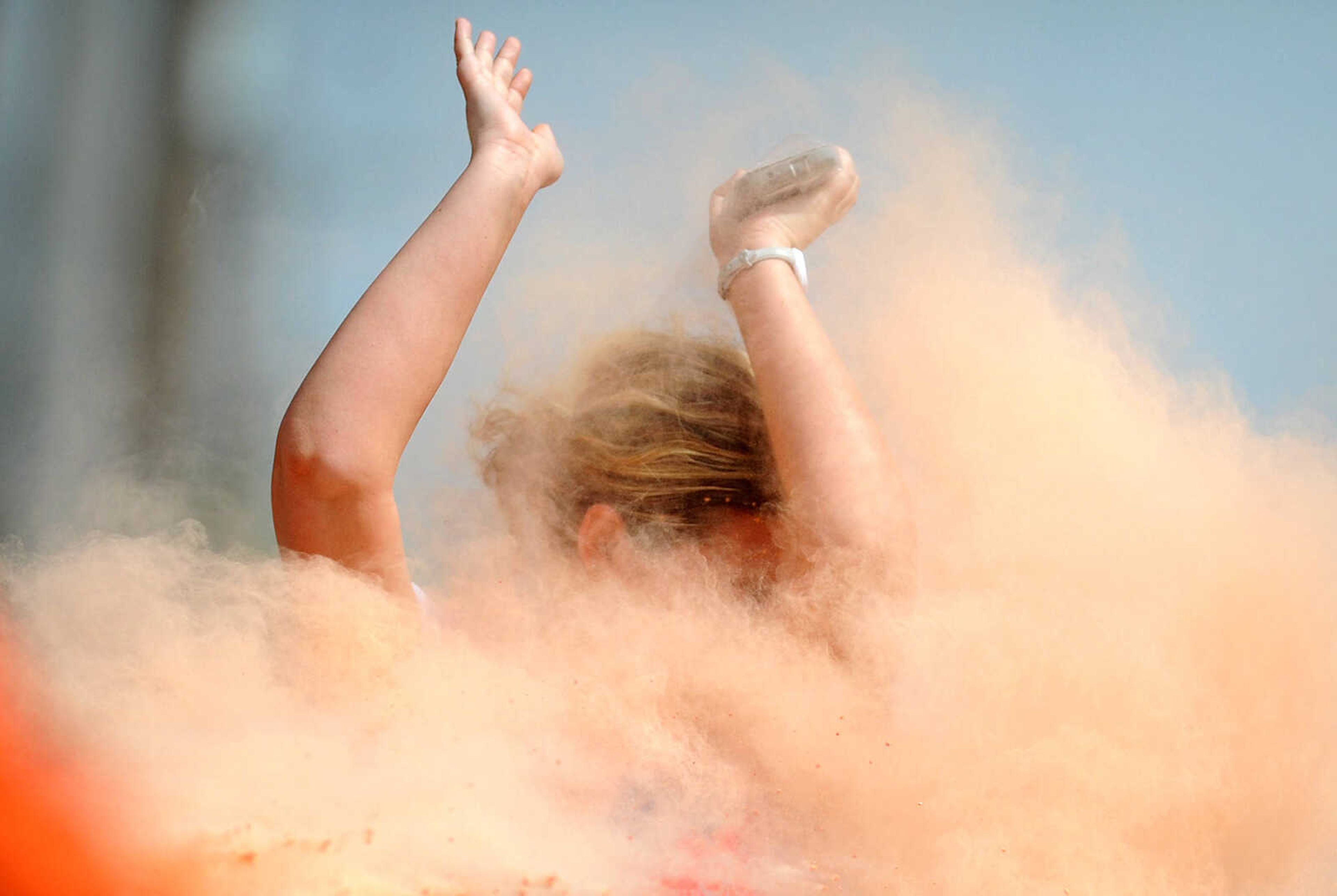 LAURA SIMON ~ lsimon@semissourian.com

Participants in the Color Me Cape 5K are sprayed with orange powder at the first color station on Good Hope Street, Saturday, April 12, 2014, in Cape Girardeau.