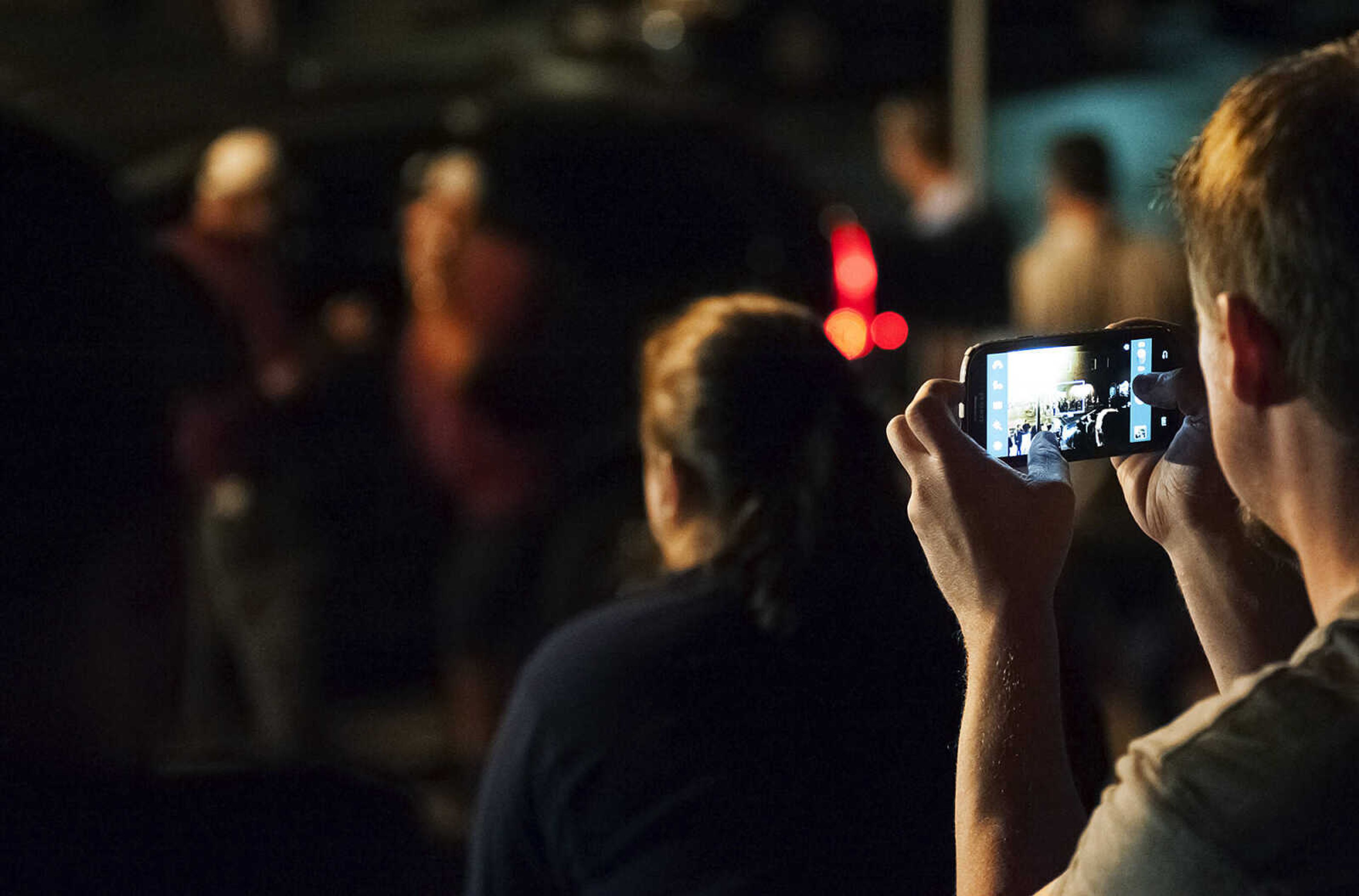 ADAM VOGLER ~ avogler@semissourian.com
A spectator takes a photo with his phone as crew members set up to film a scene for the 20th Century Fox feature film "Gone Girl," Friday, Sept. 27, in downtown Cape Girardeau. Directed by David Fincher and staring Ben Affleck and Rosamund Pike the film is expected to be filming in the Cape Girardeau area for several weeks.