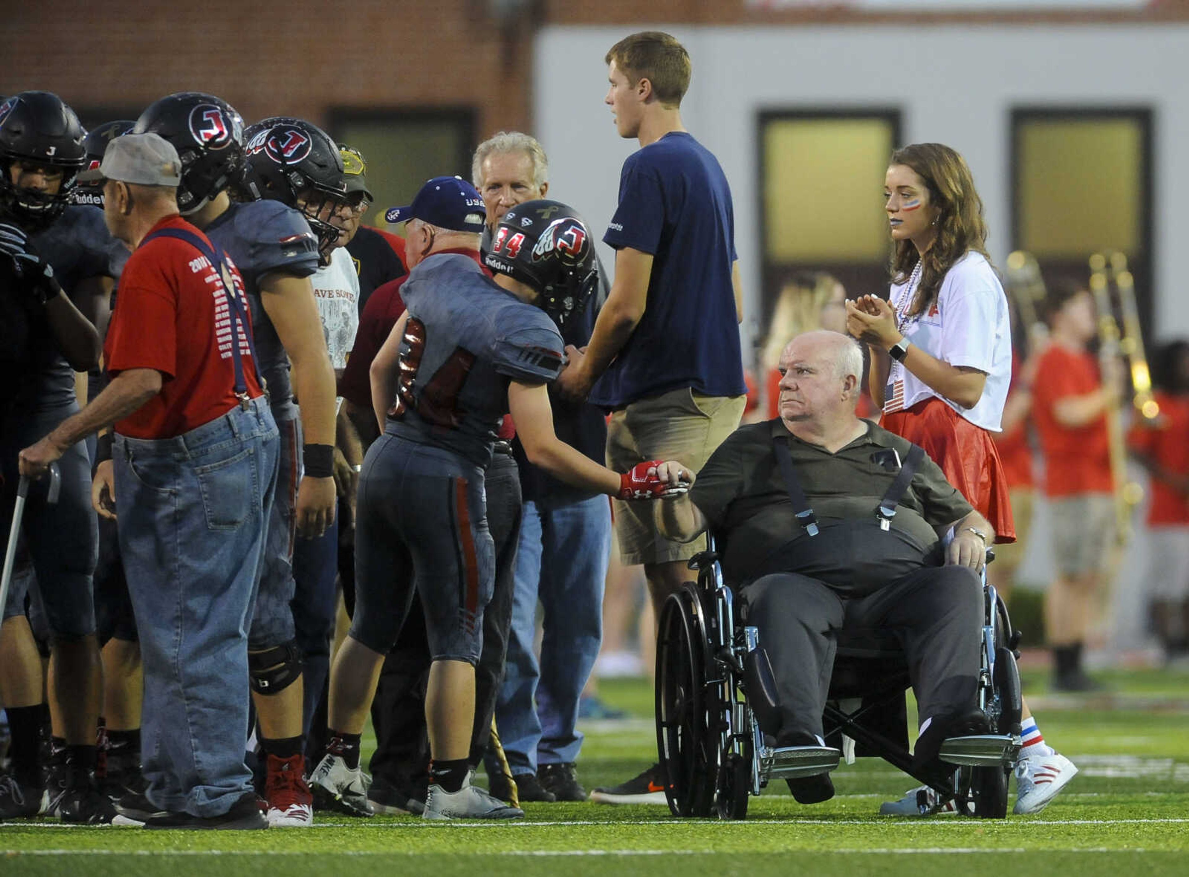 Jackson wide receiver Matthew Stroder shakes hands with Vietnam veteran Wayne Schmitt, age 70, before the start of a game against Poplar Bluff on Friday, Oct. 5, 2018, at Jackson High School.