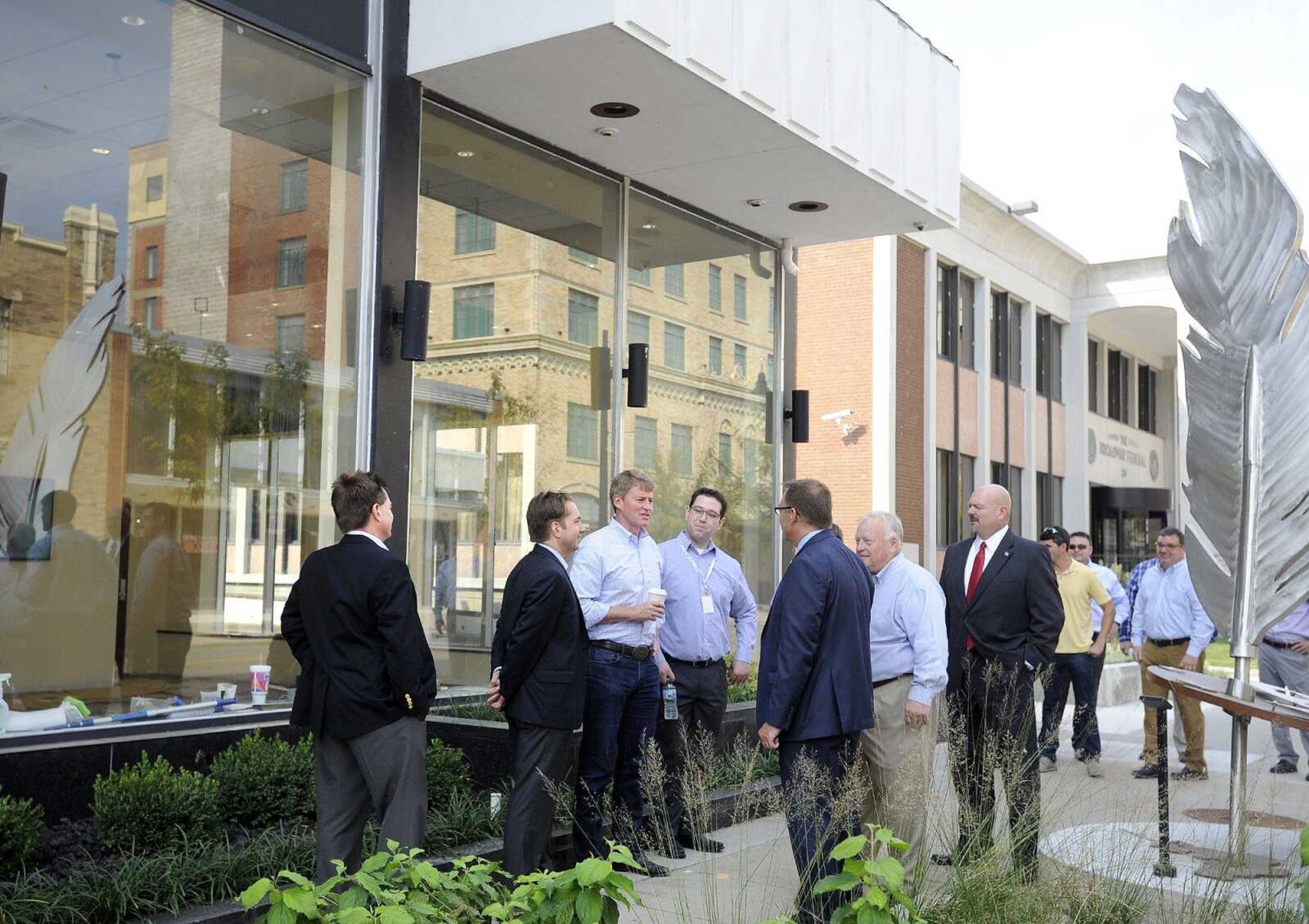 From left to right, Rex Rust, co-president of Rust Communications; Jon K. Rust, publisher of the Southeast Missourian and co-president of Rust Communications; Missouri Attorney General Chris Koster; Lucas Presson, general manager of rustmedia; Karl Kunkel, Southeast Missouri State University provost; Jerry Ford; and Jay Knudston talk outside Southeast Missouri State University's new Rust Center for Media during Koster's stop in Cape Girardeau on Thursday. Koster toured the Rust Center for Media, the Broadway Federal, the Marquette Tower and the H-H Building.