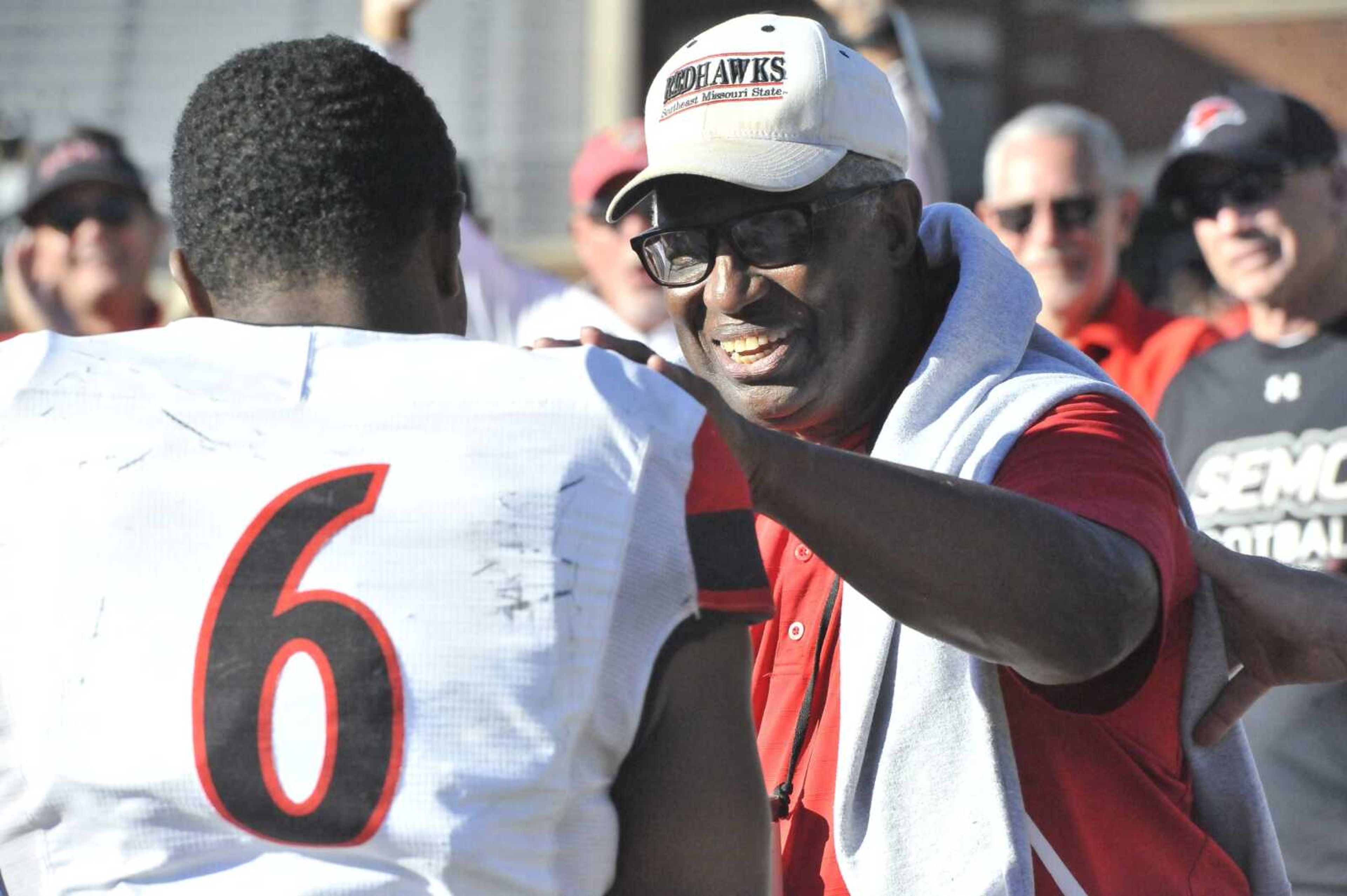 Southeast Missouri State junior running back Geno Hess meets former Redhawk great Walter Smallwood after breaking Smallwood's career touchdown record in a win earlier this year at Lindenwood in St. Charles, Missouri. Smallwood and former SEMO basketball MVP Curtis Williams have been honored with a street named after them.