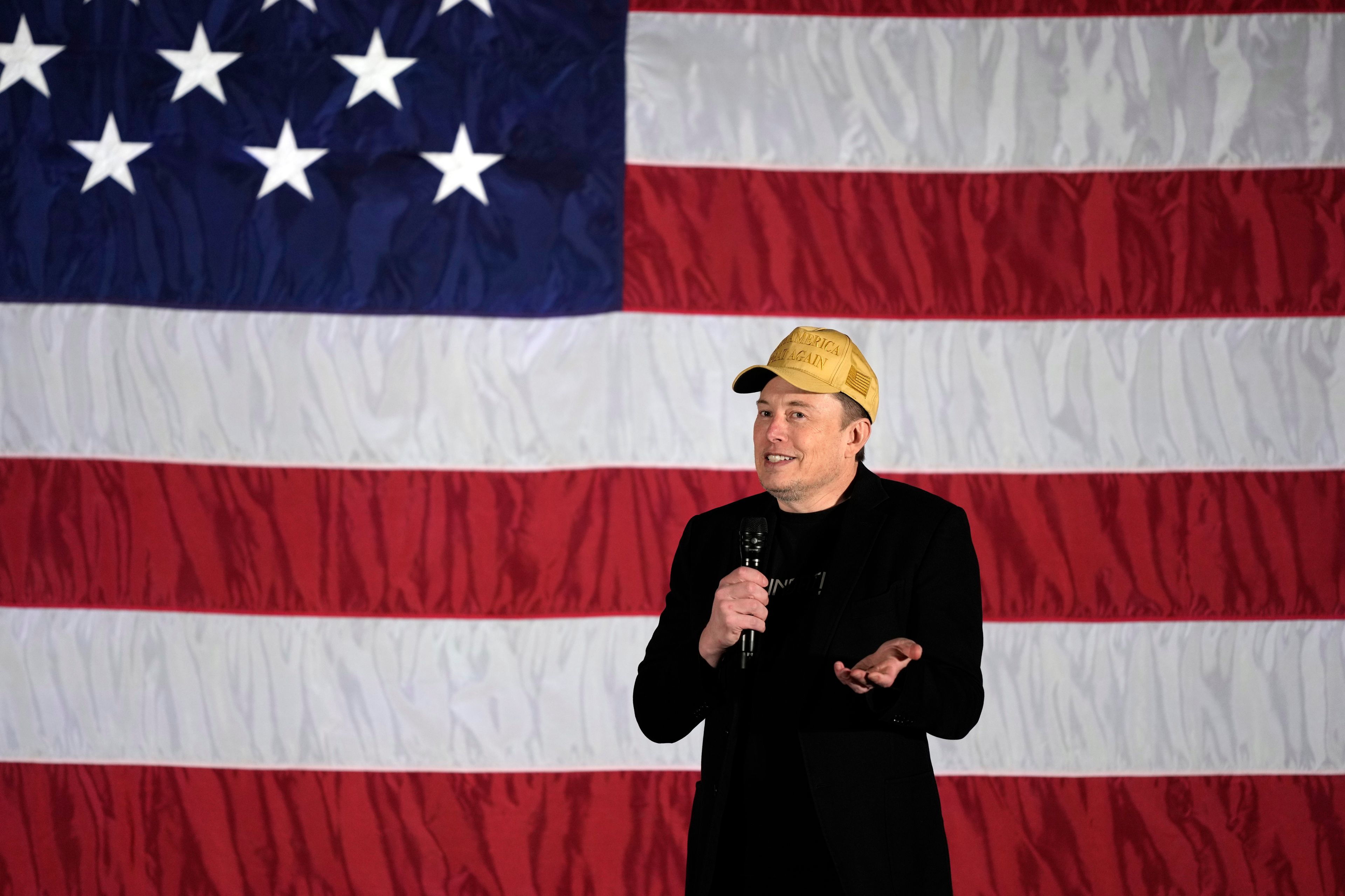 Elon Musk speaks as part of a campaign town hall in support of Republican presidential nominee former President Donald Trump in Folsom, Pa., Thursday, Oct. 17, 2024. (AP Photo/Matt Rourke)