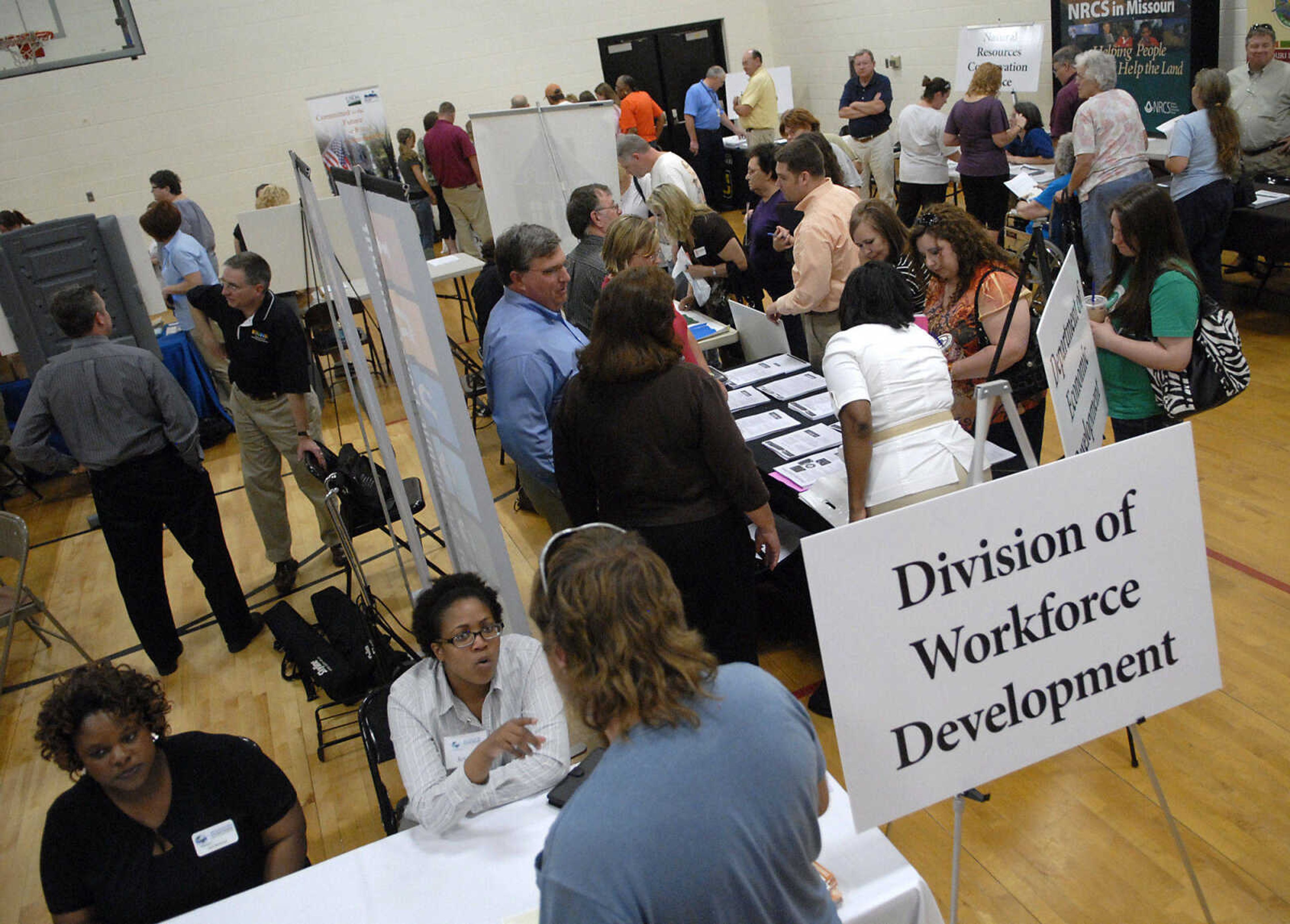 KRISTIN EBERTS ~ keberts@semissourian.com

People visit booths for different agencies during a Community Response Meeting in Sikeston Mo., on Tuesday, May 10, 2011. The meeting aimed to assist flood victims by connecting them with state programs and agencies that can help them recover.