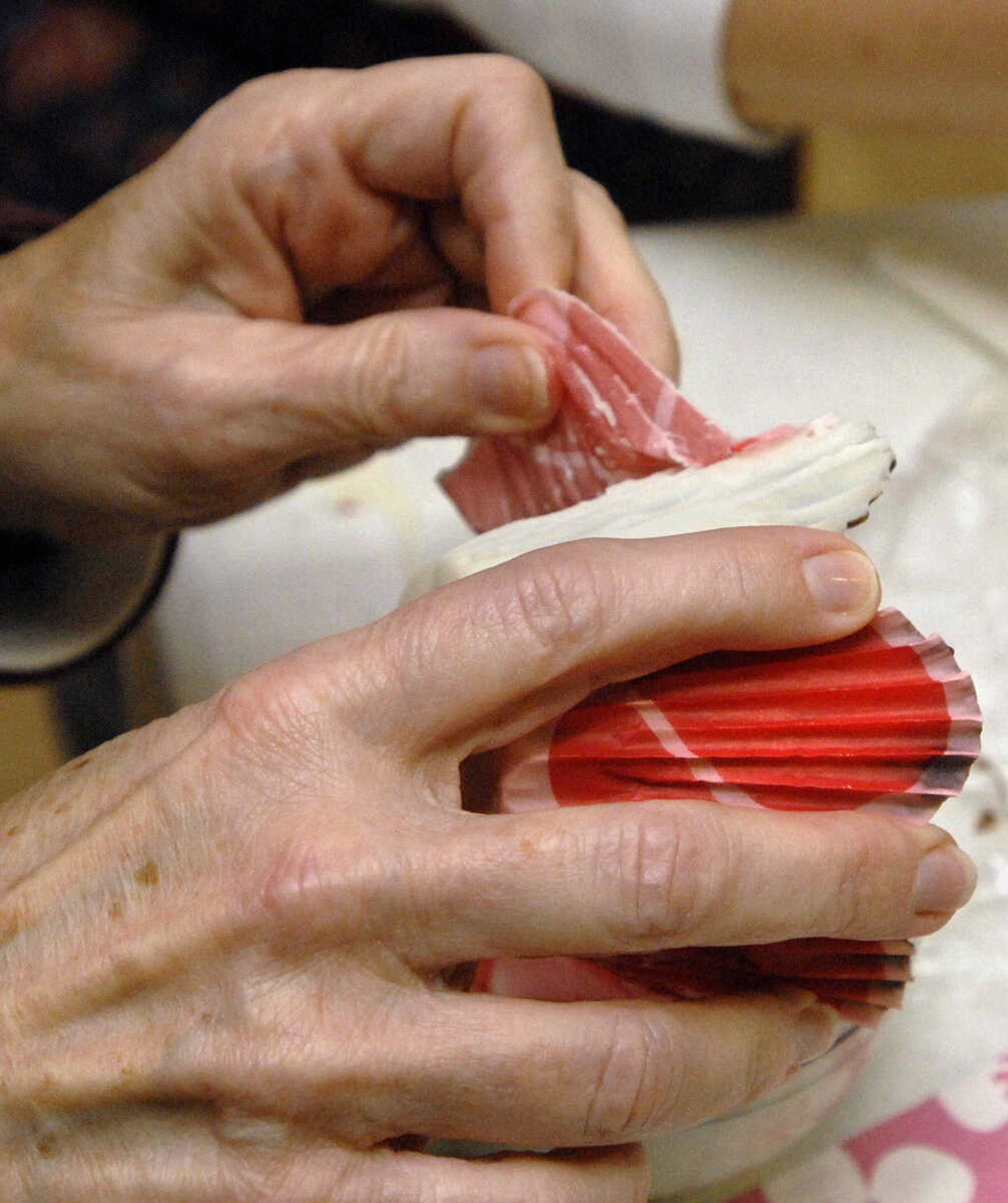 LAURA SIMON~lsimon@semissourian.com
The paper shell is carefully removed, leaving a white chocolate cup to be filled with goodies Saturday, February 5, 2011.