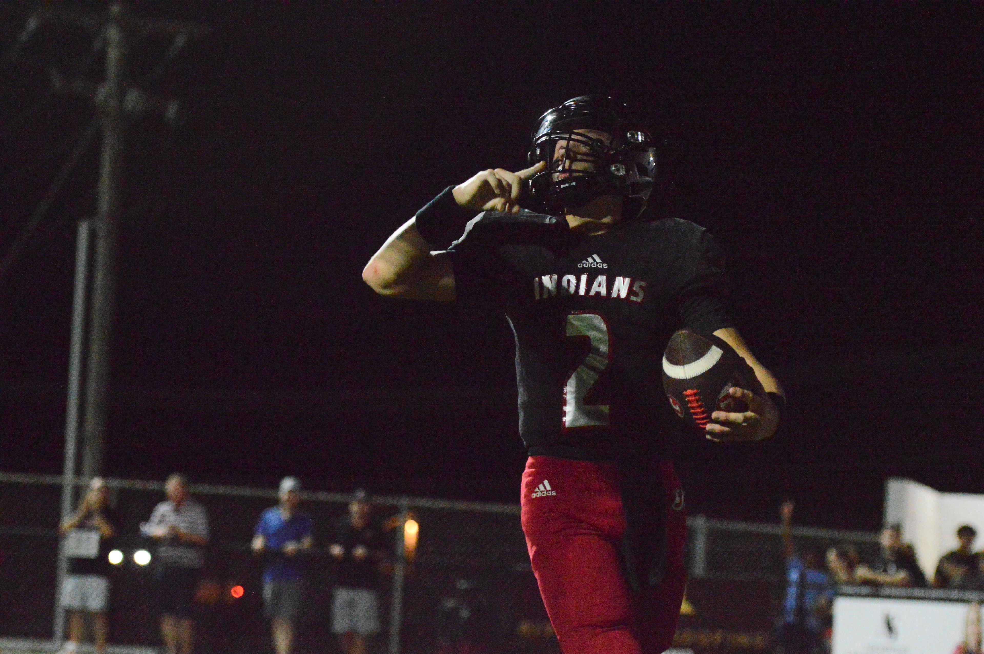 Jackson quarterback Drew Parsons celebrates after scoring a rushing touchdown against Farmington on Friday, Sept. 20. The Indians defeated the Knights, 49-35, in a high-scoring Homecoming night matchup.