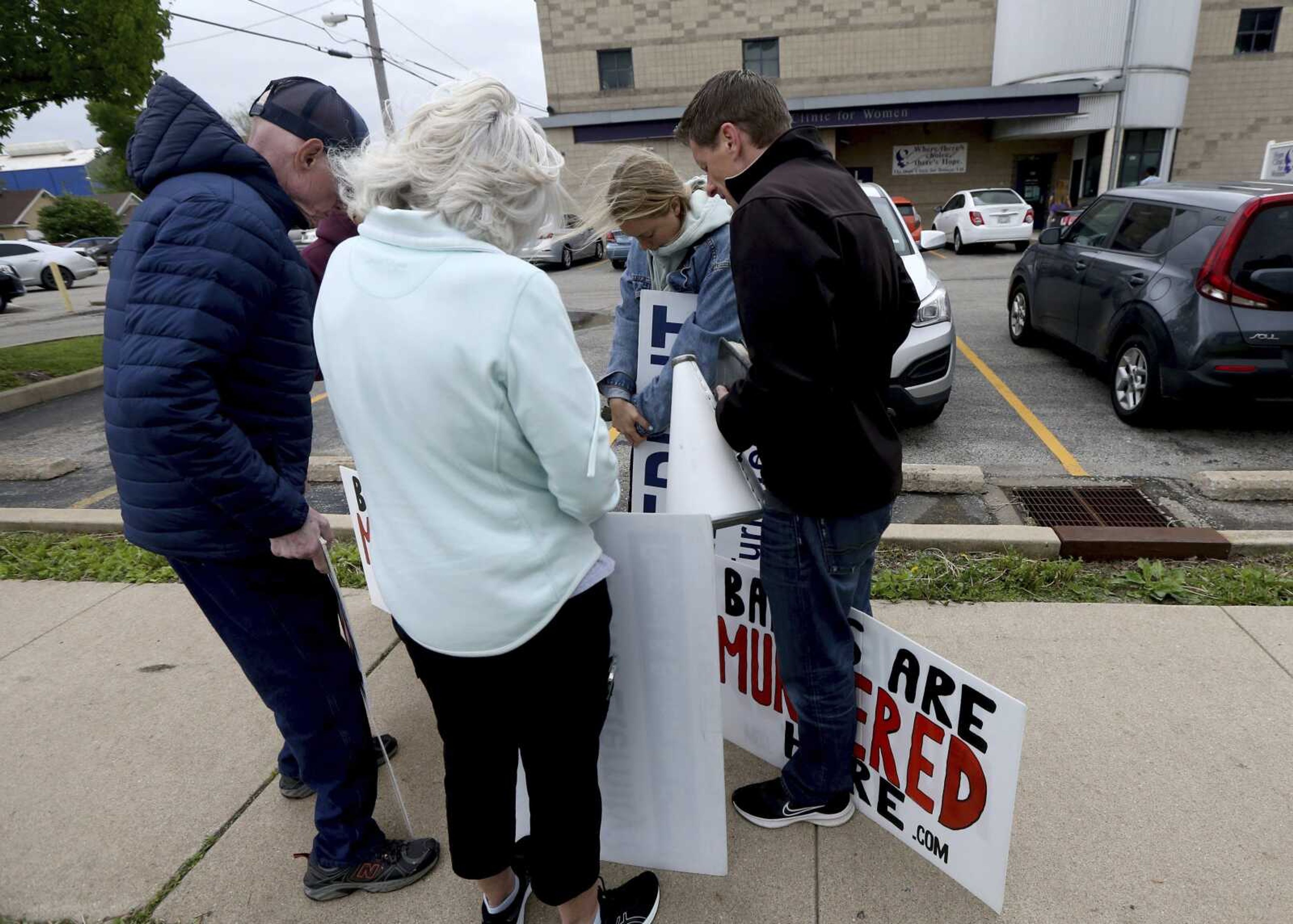 Anti-abortion protesters from Christ Fellowship Bible Church in Brentwood, Missouri, pray Tuesday outside Hope Clinic in Granite City, Illinois. Metro East clinics are forecasting a surge in out-of-state patients if the Supreme Court indeed overturns federal abortion protections.