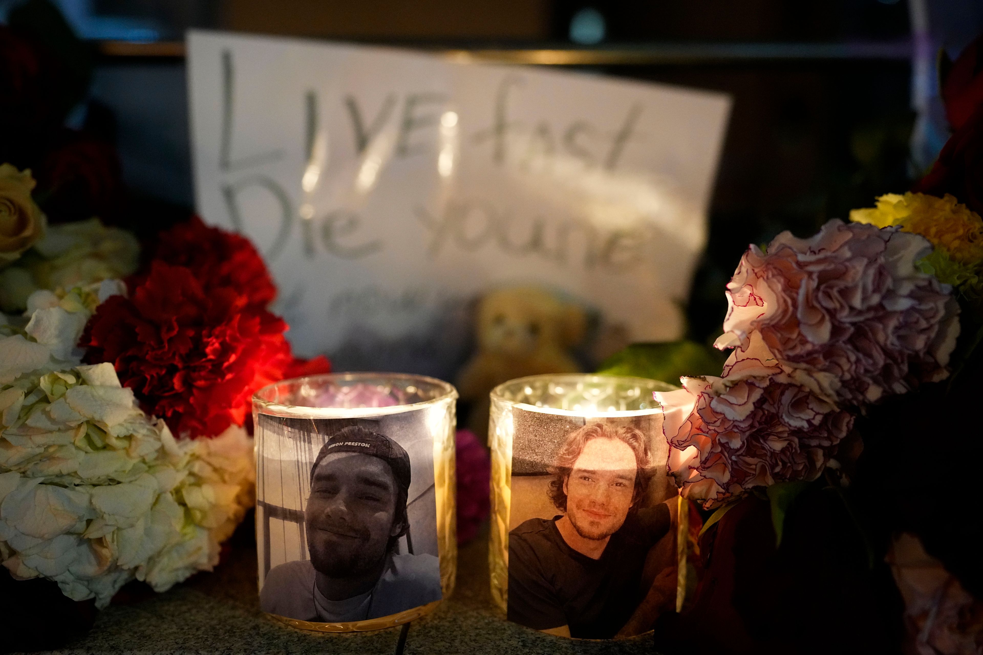 Candles with portraits of late British singer and former One Direction band member Liam Payne are seen next to the British embassy in Moscow, Russia, Friday, Oct. 18, 2024. (AP Photo/Pavel Bednyakov)