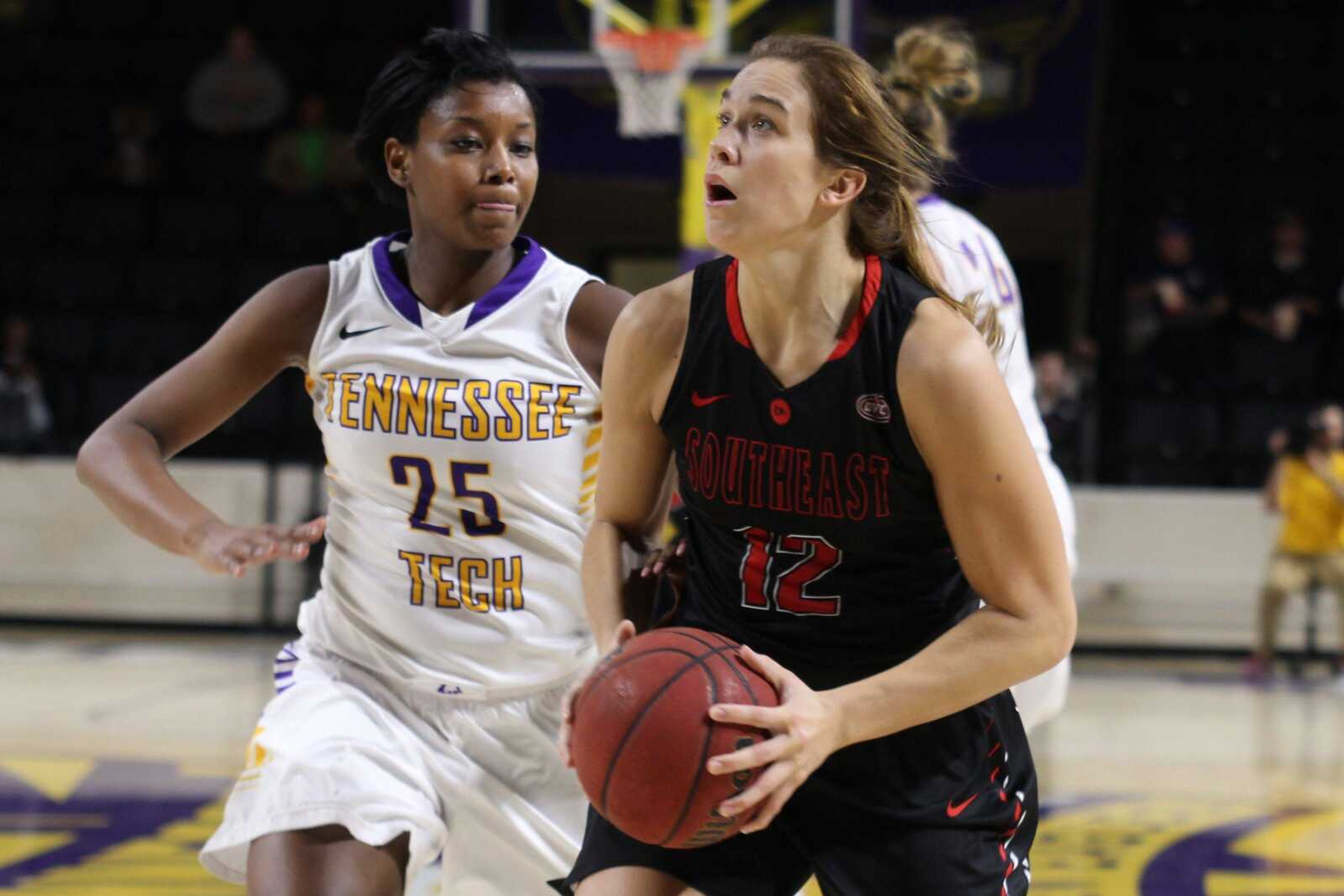 Southeast Missouri State's Erin Bollmann drives past Tennessee Tech's Asia Harper during Saturday's game in Cookeville, Tennessee. The Redhawks won 60-57. (Tony Marable ~ Cookeville Herald Citizen)