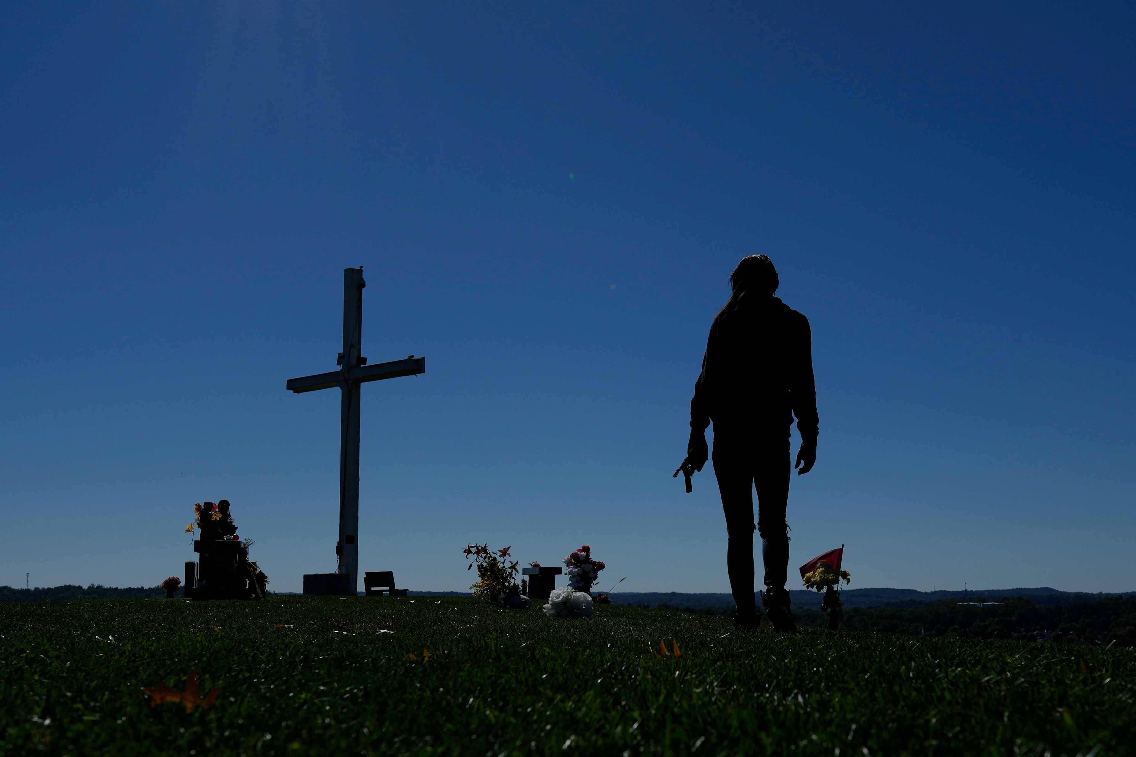 April Youst walks through a cemetery, where she says it is beautiful and quiet, in West Virginia on Wednesday, Oct. 9, 2024. (AP Photo/Carolyn Kaster)