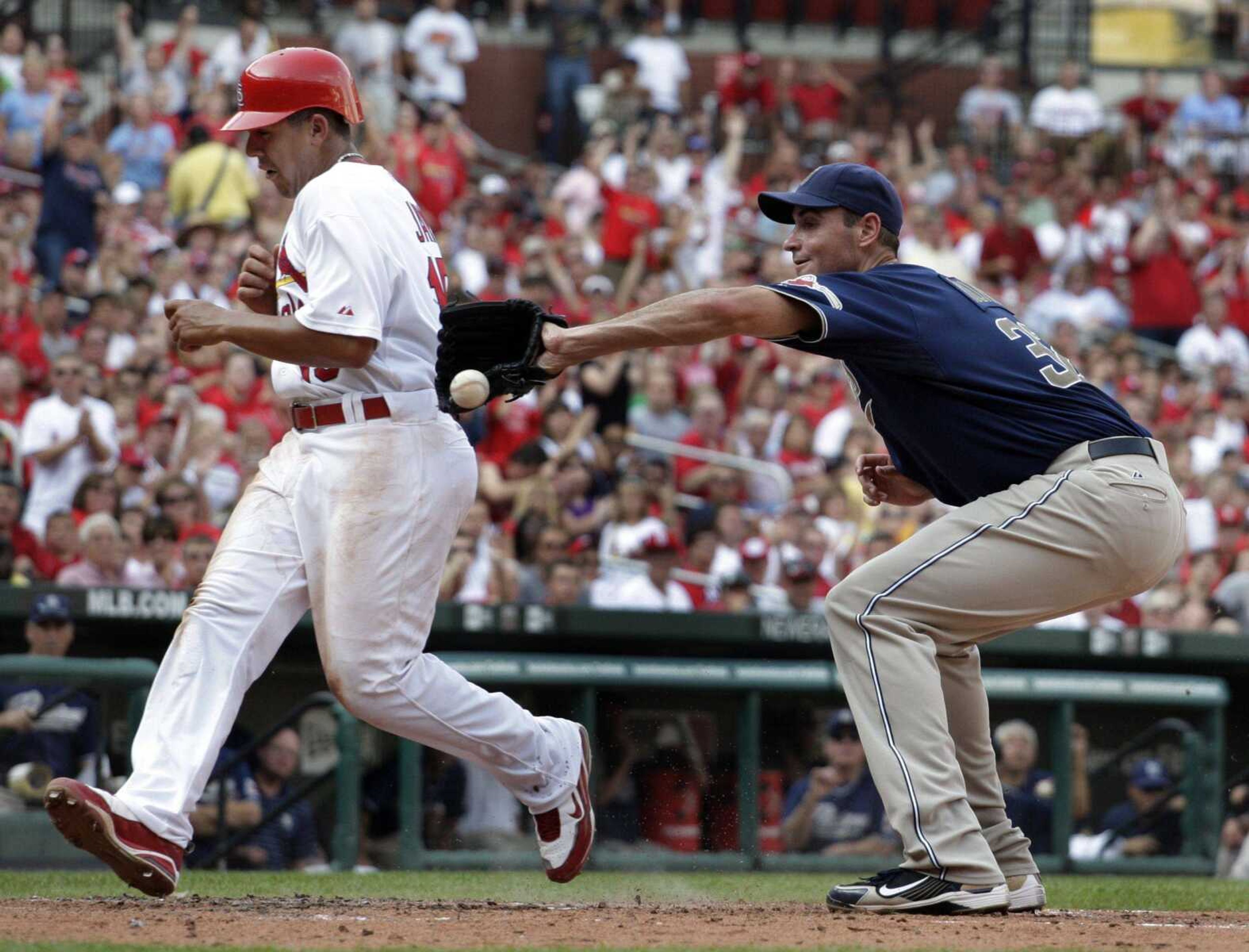 Cardinals base runner Jon Jay scores on a wild pitch by Padres starting pitcher Chris Young, who covers home during the third inning Saturday in St. Louis. (JEFF ROBERSON ~ Associated Press)