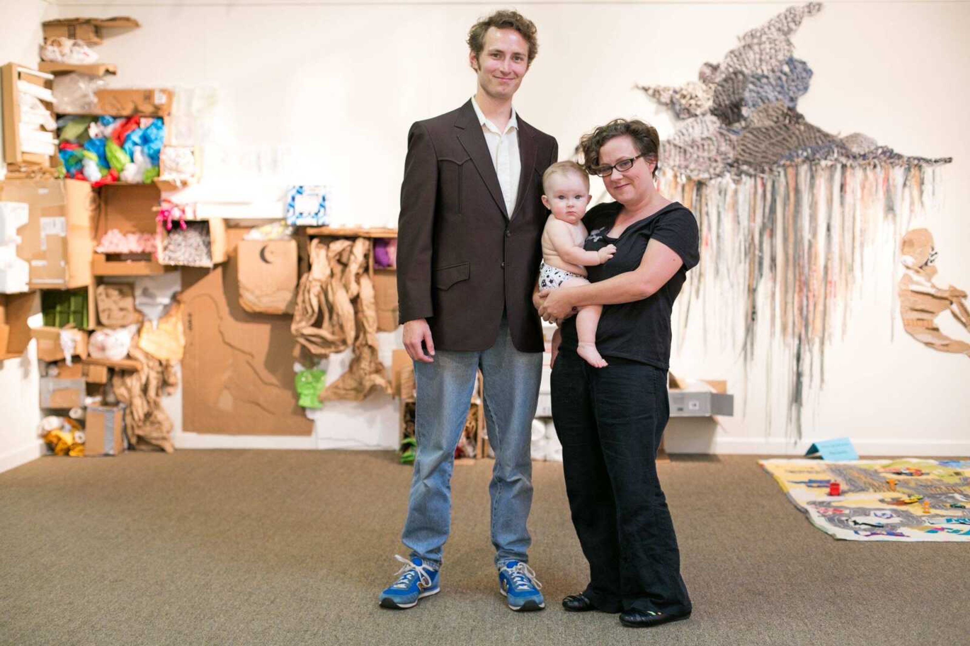 Blake and Hannah Sanders pose for a photo with their son Levee at the Arts Council of Southeast Missouri where their exhibit is on display, Thursday, Oct. 8, 2015. (Glenn Landberg)