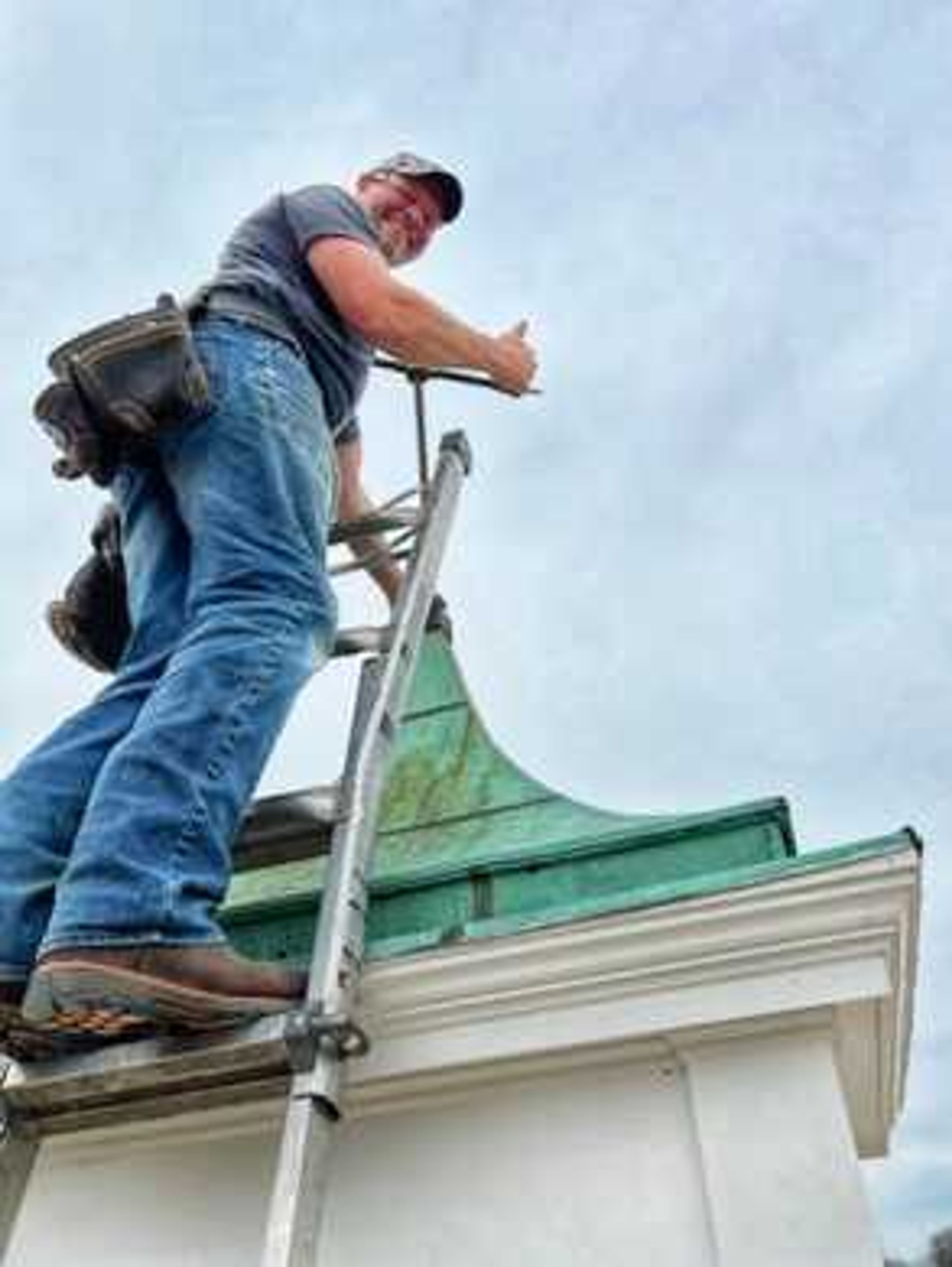 Daniel Eifert inspects restoration work on a cupola atop the historic Post Building in uptown Jackson in this undated photo.