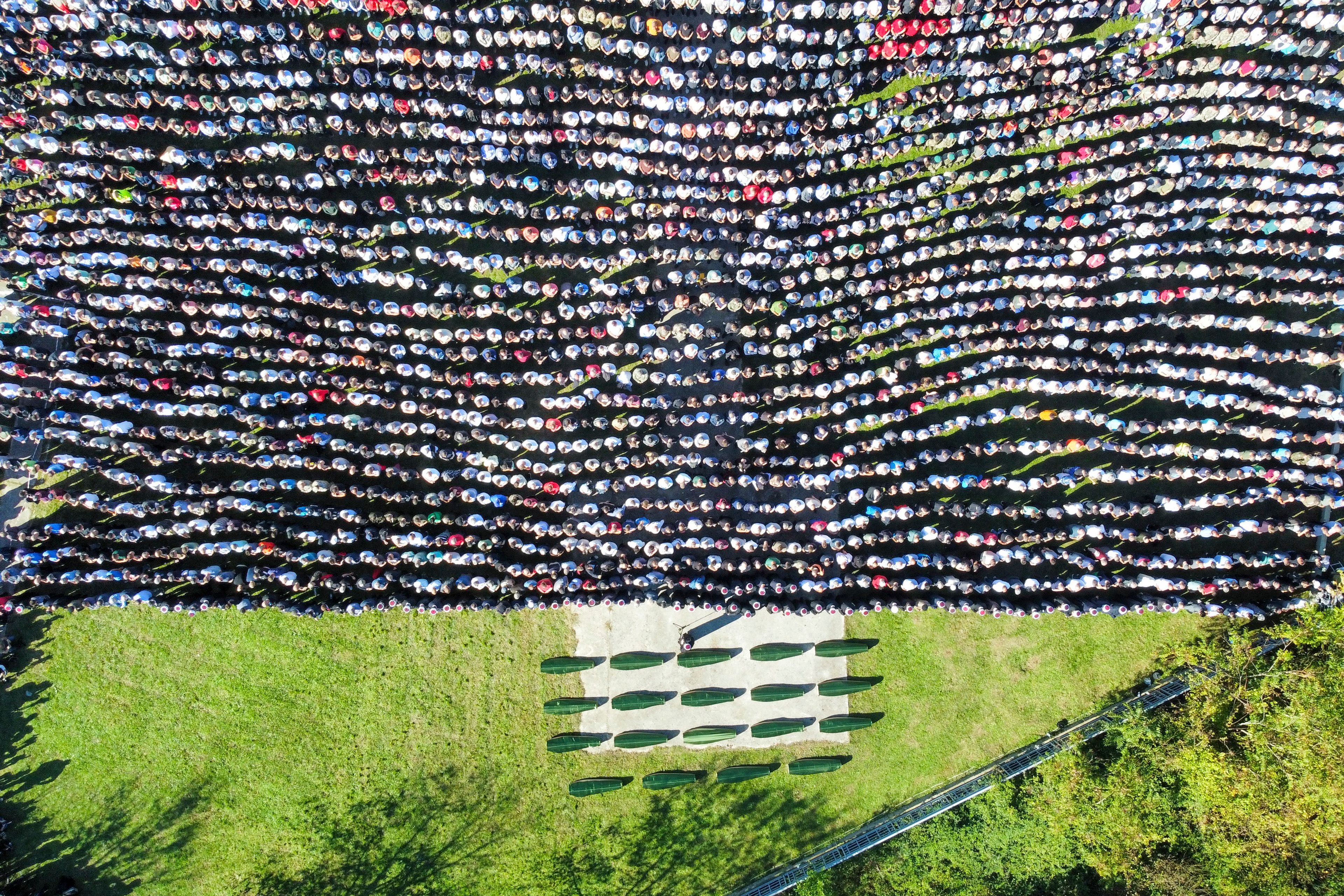 Mourners gather as they attend the collective funeral for 19 victims of a landslide caused by recent floods in Jablanica, Bosnia, Tuesday, Oct. 15, 2024. (AP Photo/Armin Durgut)