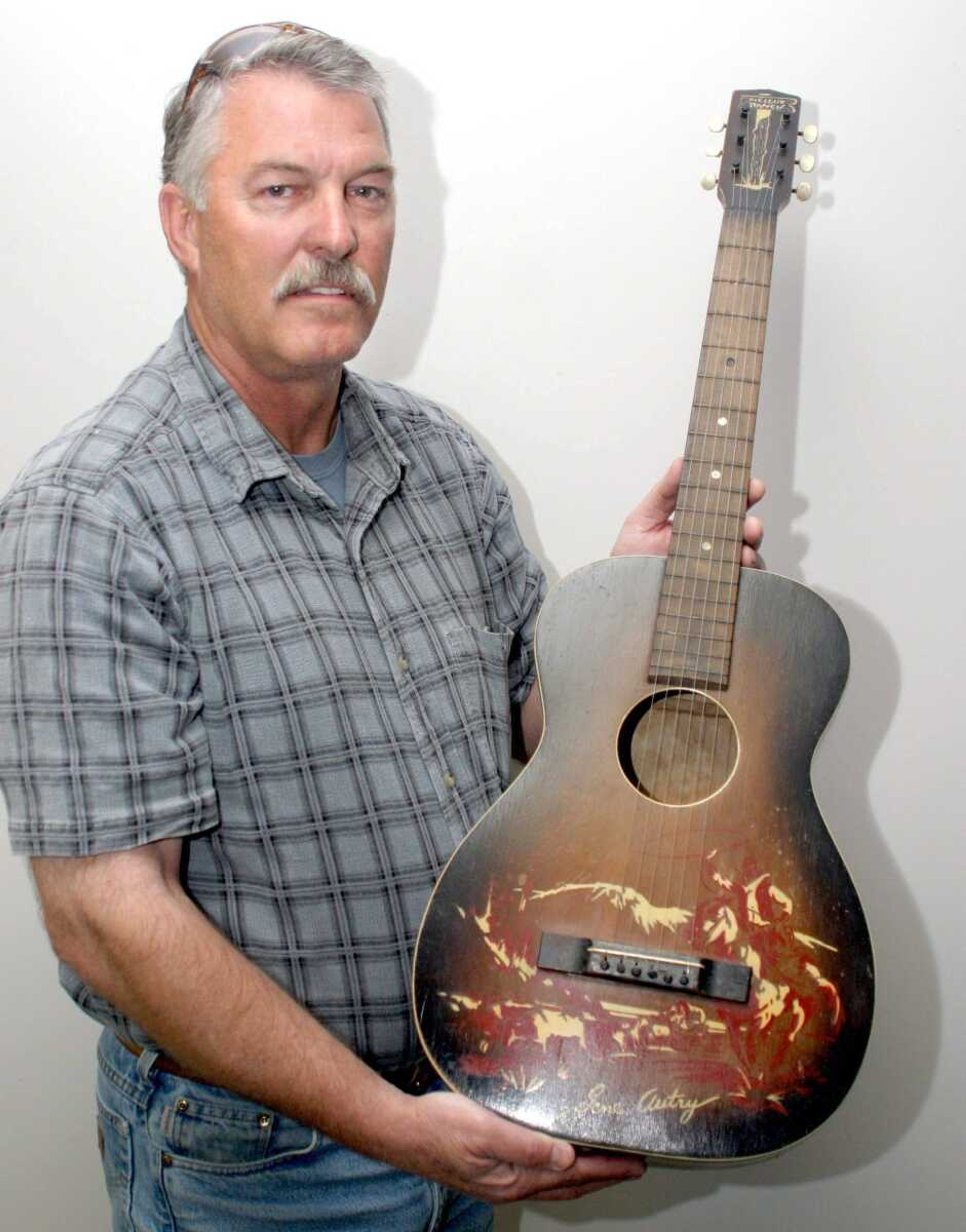 Clifford Rolwing, of Charleston, Mo., holds what he believes to be the first guitar owned by George Jones, who died April 26 at age 81. (Scott Welton ~ Standard Democrat)