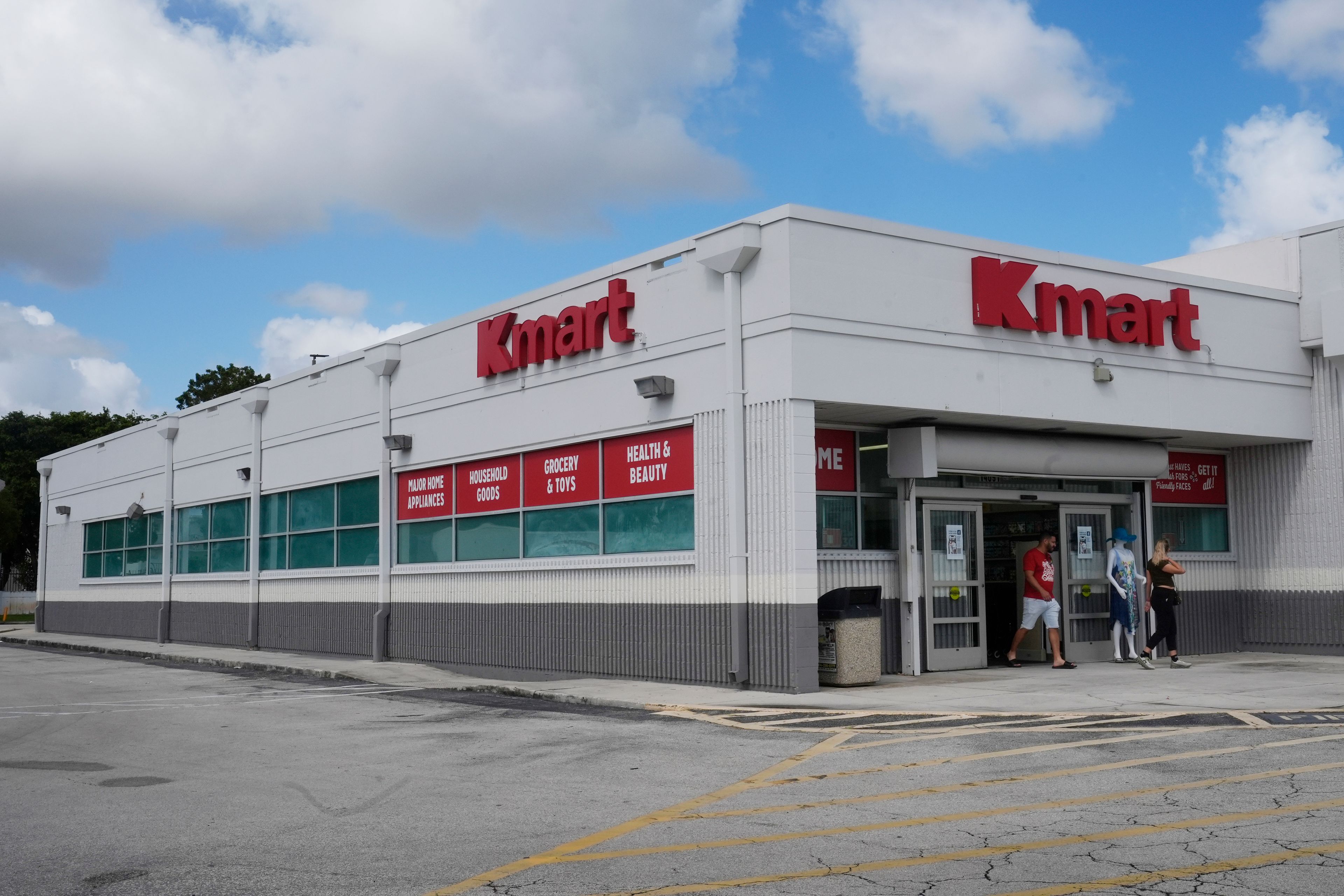 Customers leave from the only Kmart store left in the continental United States, Tuesday, Oct. 22, 2024, in Miami. (AP Photo/Marta Lavandier)