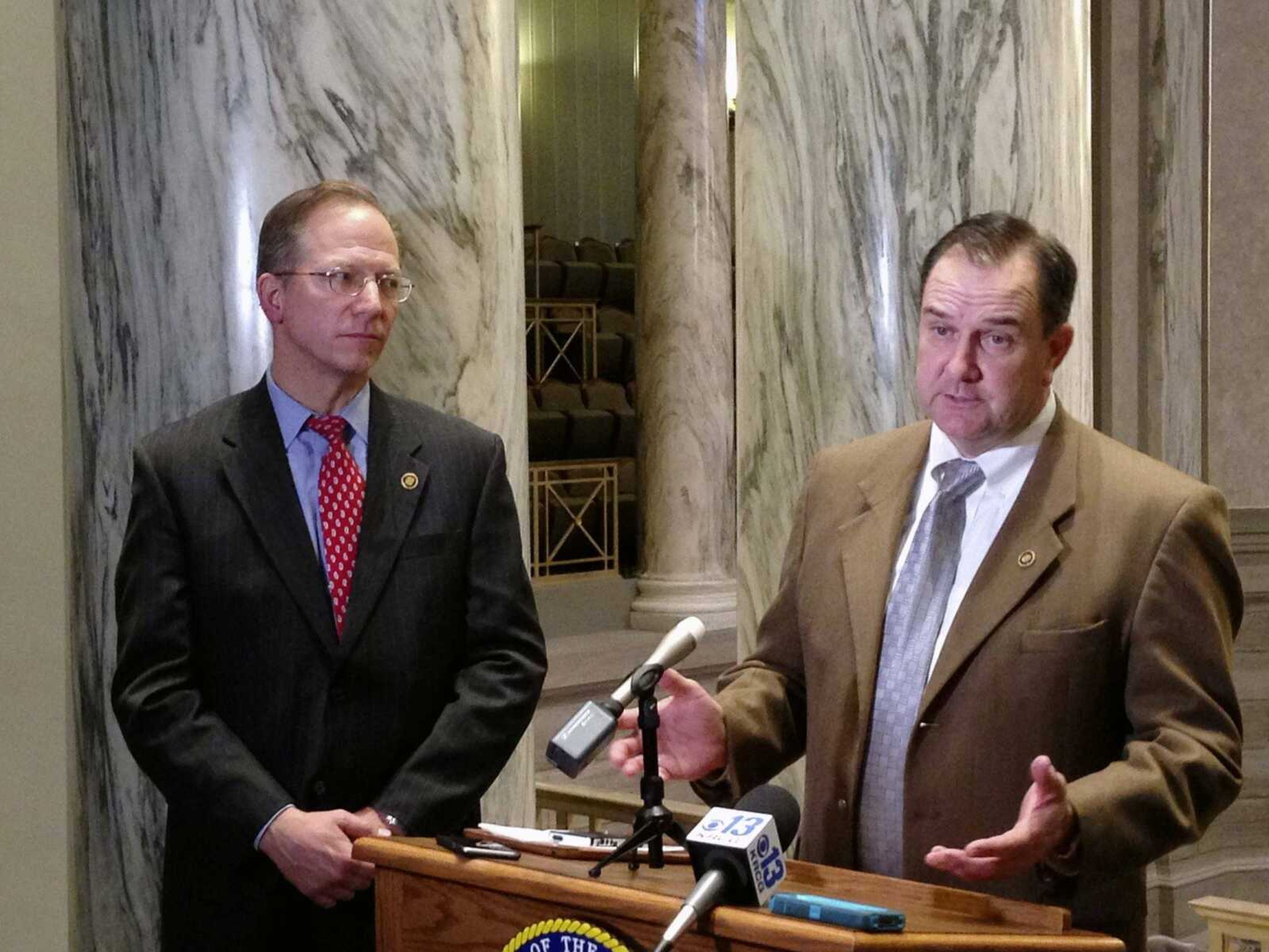 Missouri Senate Majority Leader Mike Kehoe talks with reporters as Republican Sen. Bob Onder looks on Wednesday at the Missouri Capitol in Jefferson City. Republican senators used a rare procedural move to shut off a Democratic filibuster and force a vote Wednesday on a proposed state constitutional amendment sponsored by Onder. The measure would prohibit government penalties against some businesses and individuals who cite religious beliefs while declining to provide wedding-related services to same-sex couples.