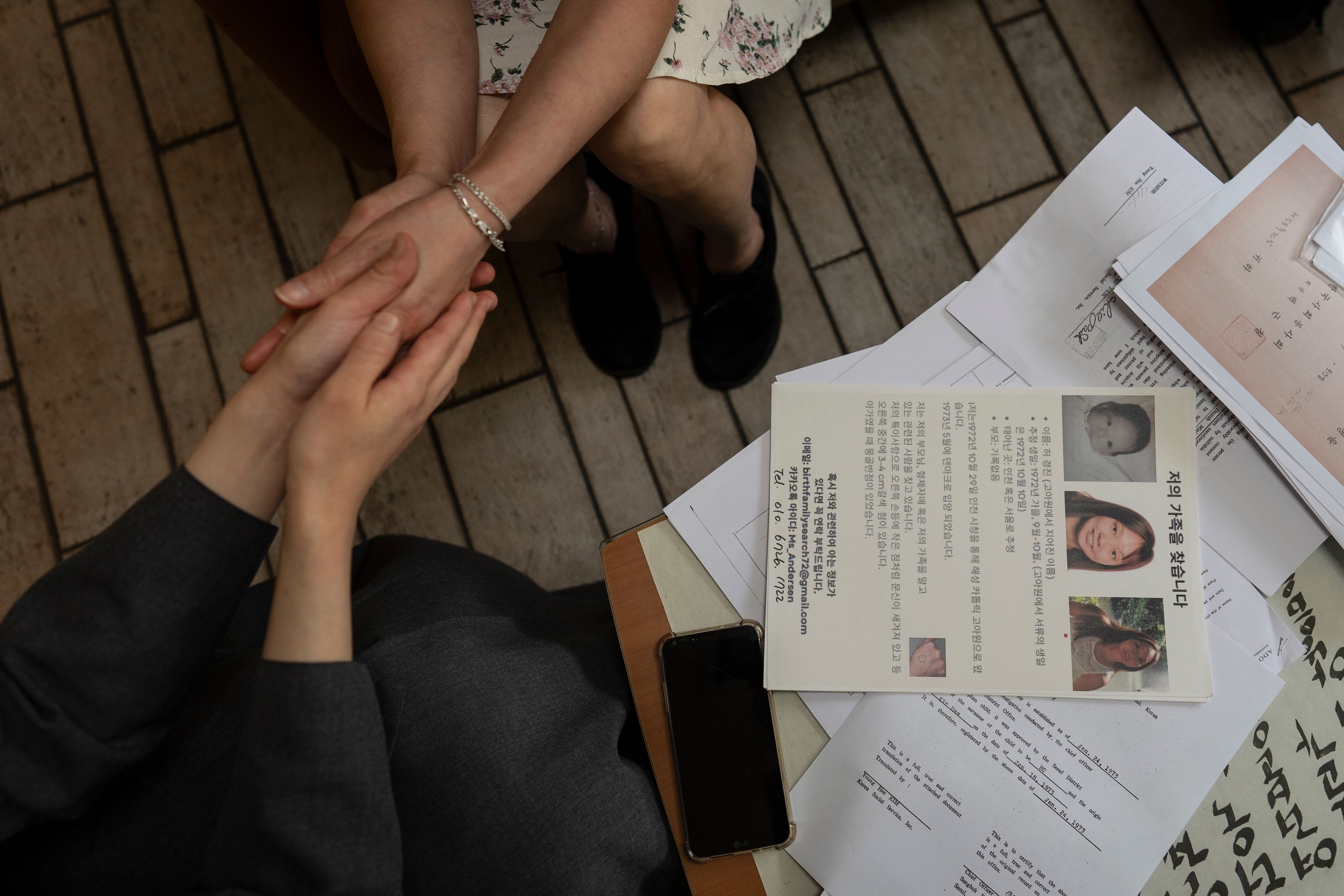 Maja Andersen, top, an adoptee visiting from Denmark to search for her birth family, holds the hands of Sister Christina Ahn at Star of the Sea orphanage in Incheon, South Korea, Monday, May 20, 2024, during her visit to look for documents in hopes of finding her family. She stayed at the facility until her adoption at seven months old. (AP Photo/Jae C. Hong)