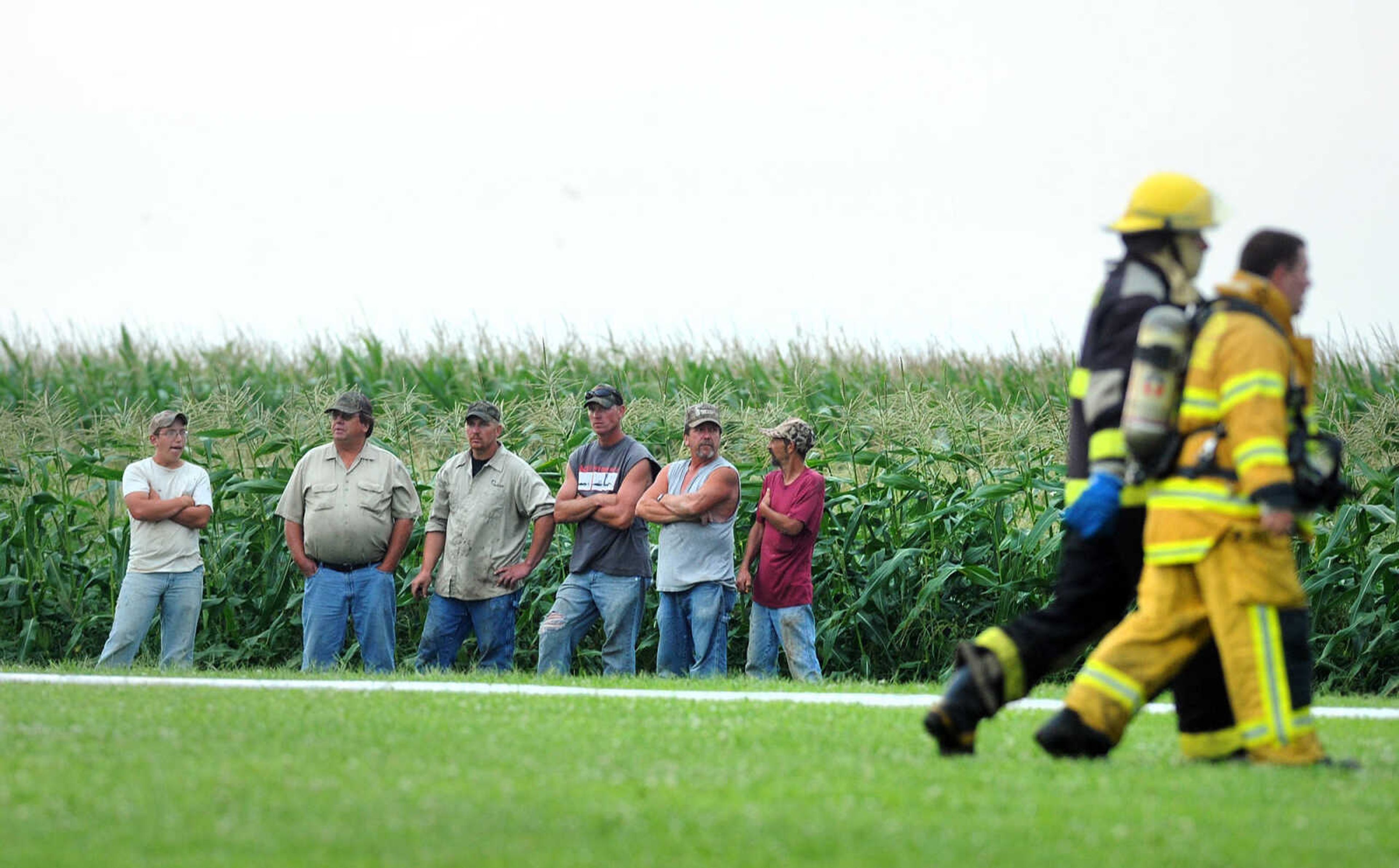 LAURA SIMON ~ lsimon@semissourian.com

People standby as firefighters from Delta, Scott City, Chaffee and New Hamburg/Benton/Commerce battle a house fire off County Road 204 in Scott County Wednesday afternoon, July 23, 2014.