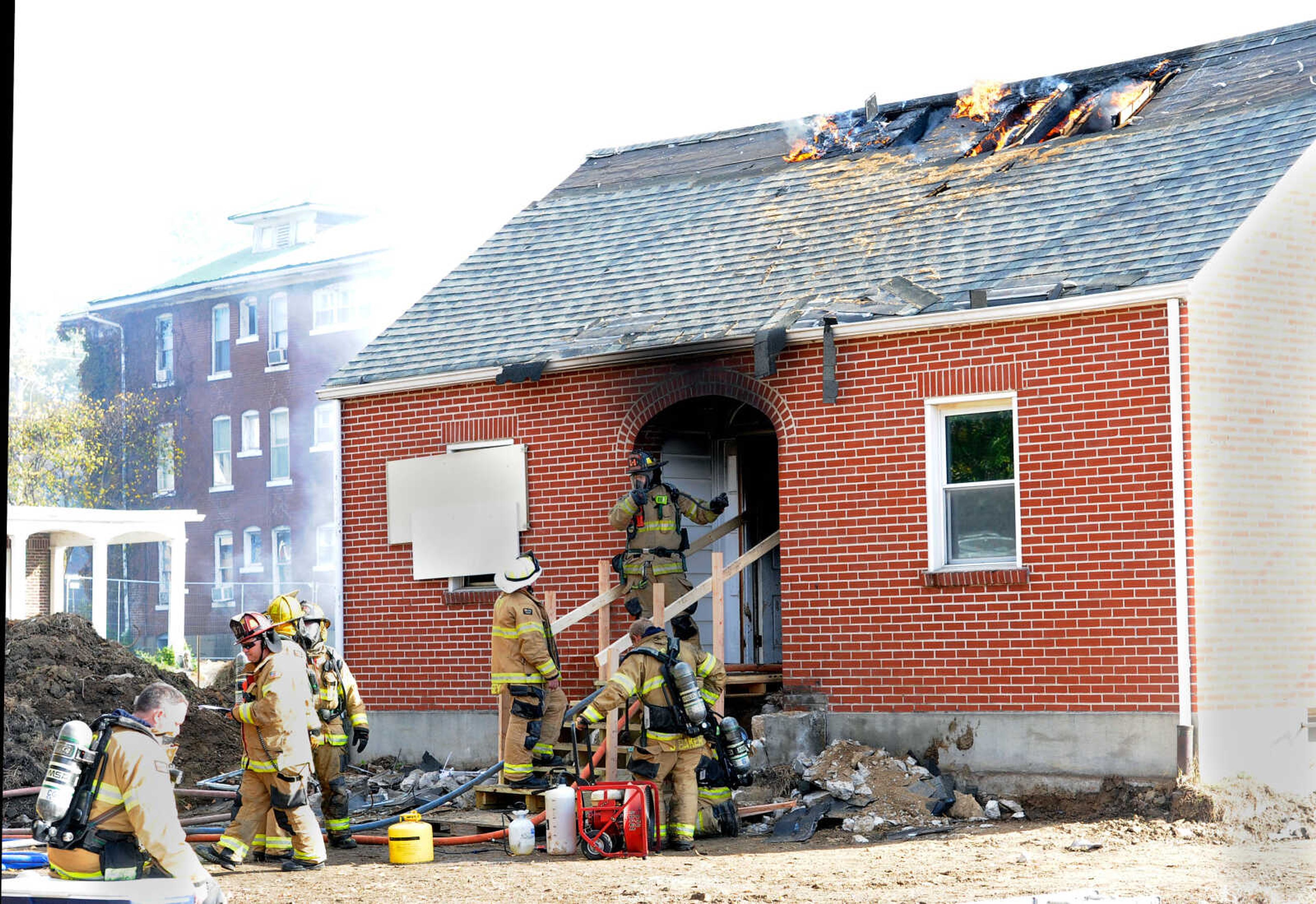 First- and second-year firefighters prepare to enter the structure at 222 N. Middle St. in Cape Girardeau for the live burn exercise on Friday, Oct. 23, 2020, held by the Cape Girardeau Fire Department.&nbsp;