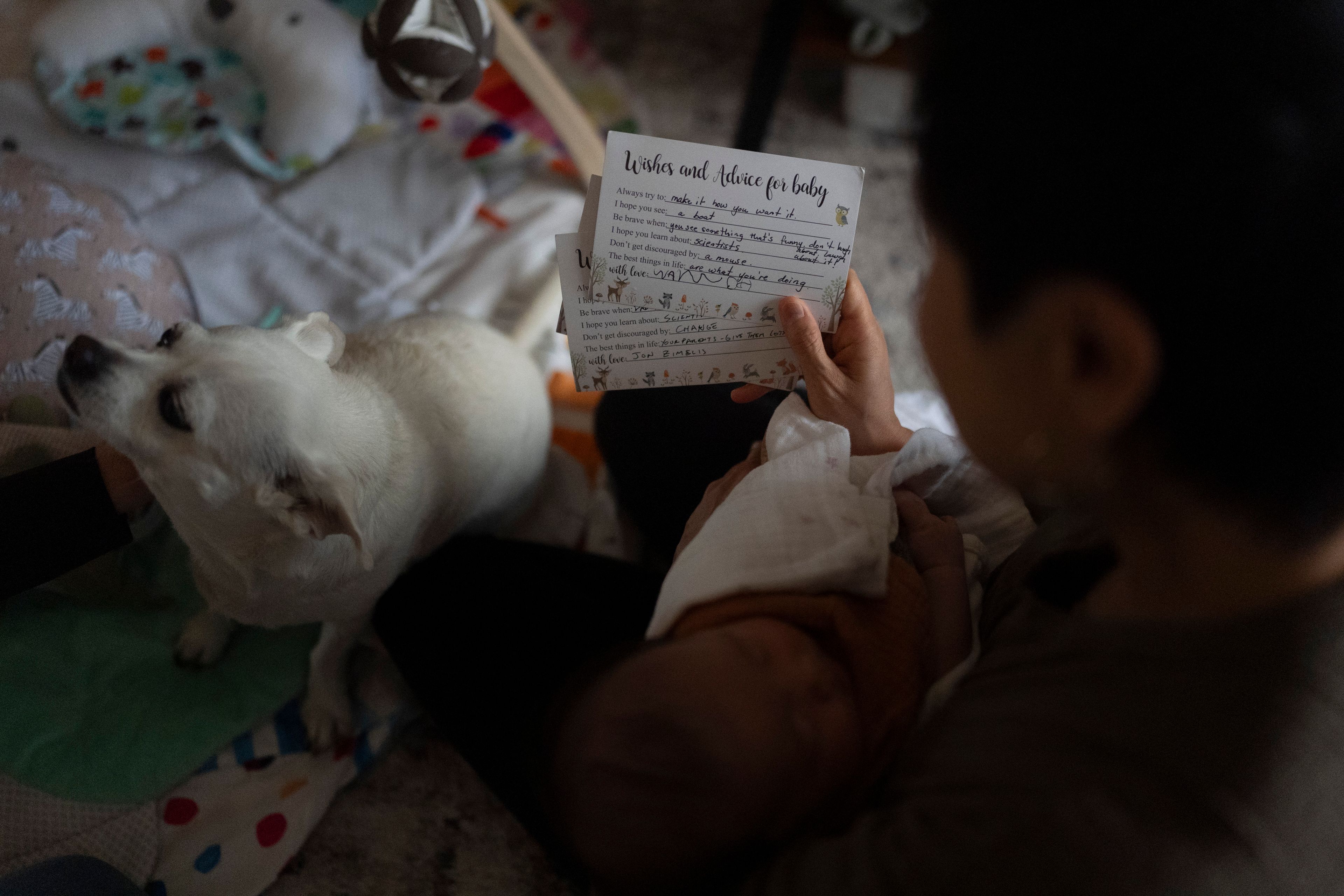 Robyn Joy Park reads a card offering best wishes and advice for her daughter, Rae, at her home in Pasadena, Calif., Friday, April 19, 2024. The card was written by the daughter of Michaela Dietz. Park and Dietz were both adopted as children from South Korea, and later learned their identities were switched with other children. (AP Photo/Jae C. Hong)