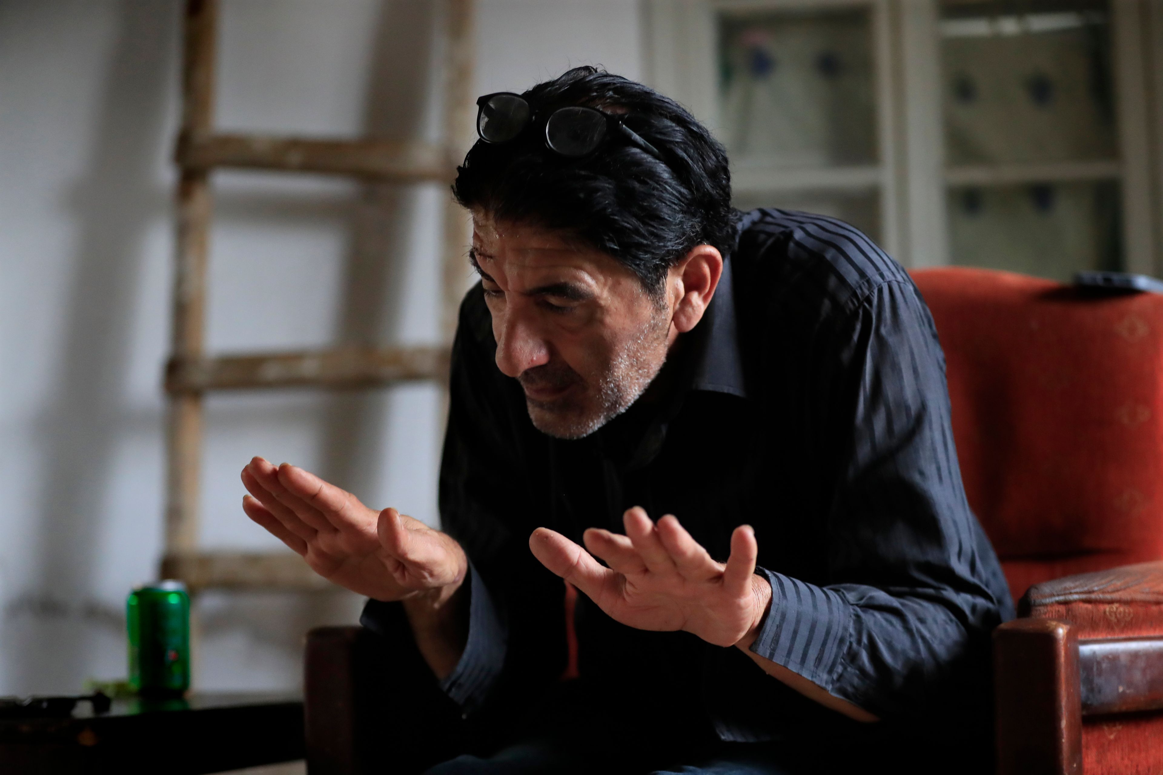 Hecham al-Baba, who survived the deadliest attack on Sept. 29 in the first week of escalation between Israel and Hezbollah and who lost his sister and her family who were also killed at destroyed building that was hit by an Israeli airstrike, gestures at his family home in the southern port city of Sidon, Lebanon, Thursday, Oct. 10, 2024. (AP Photo/Mohammed Zaatari)