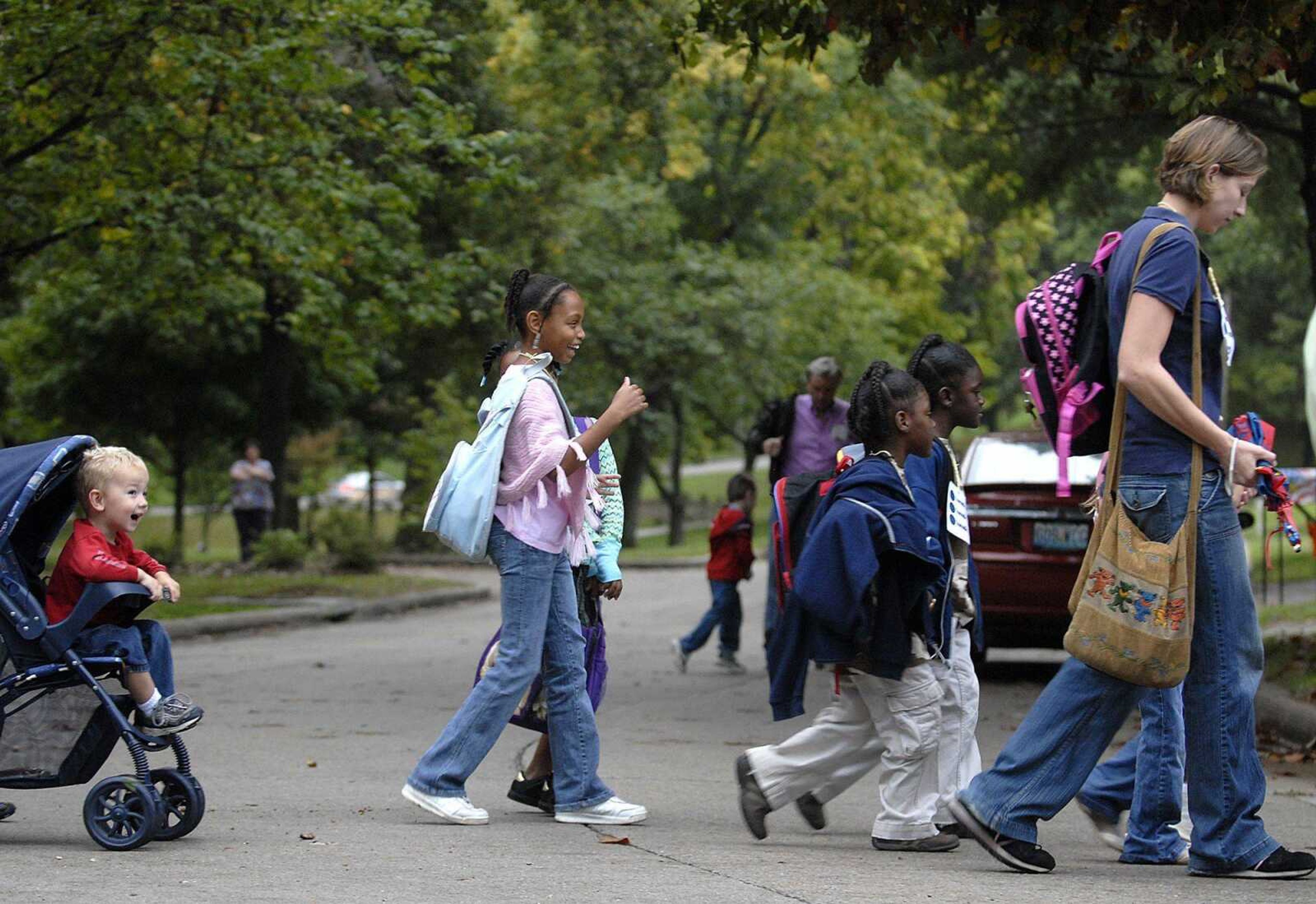 Students, parents and teachers make their way across Brookwood Drive from Dennis Scivally Park on Wednesday during their trip to Alma Schrader Elementary School during International Walk to School Day.

AARON EISENHAUER ~ aeisenhauer@semissourian.com