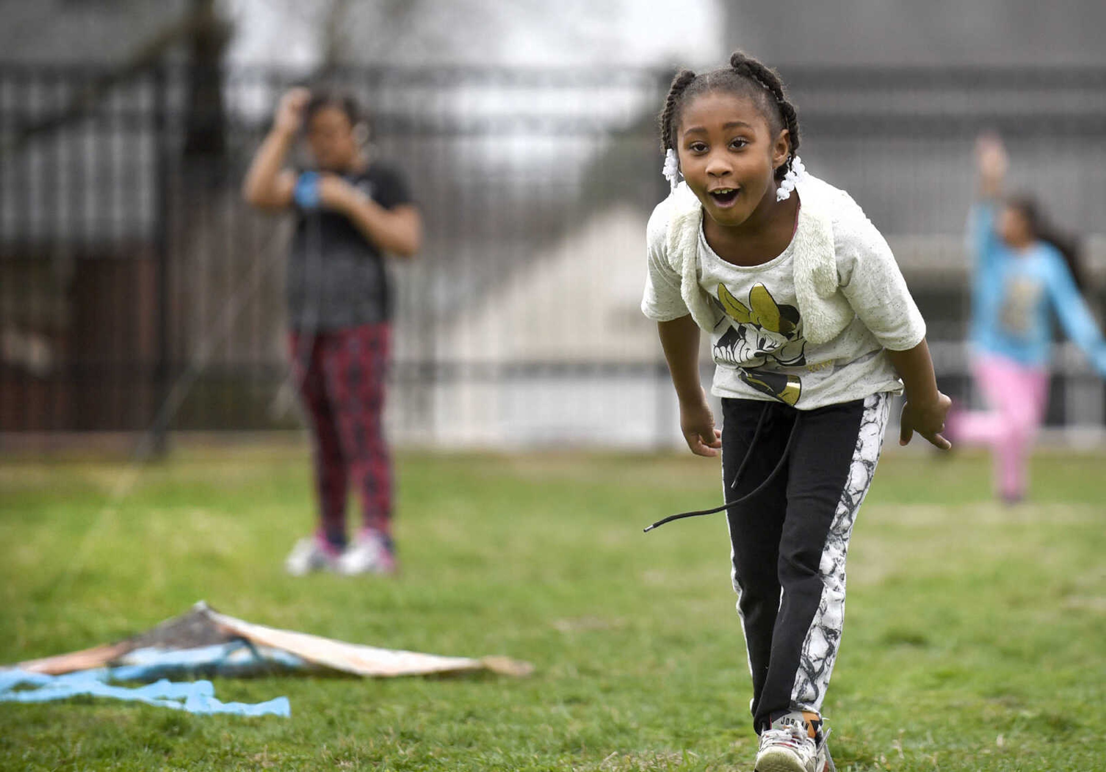 Ahexya Jones reacts after letting go of her kite on the playground on Friday, Feb. 24, 2017, at Franklin Elementary in Cape Girardeau. Lyndora Hughes second grade class spent a portion of the afternoon flying their kites as part of their story celebration for reading "Gloria Who Might Be My Best Friend".