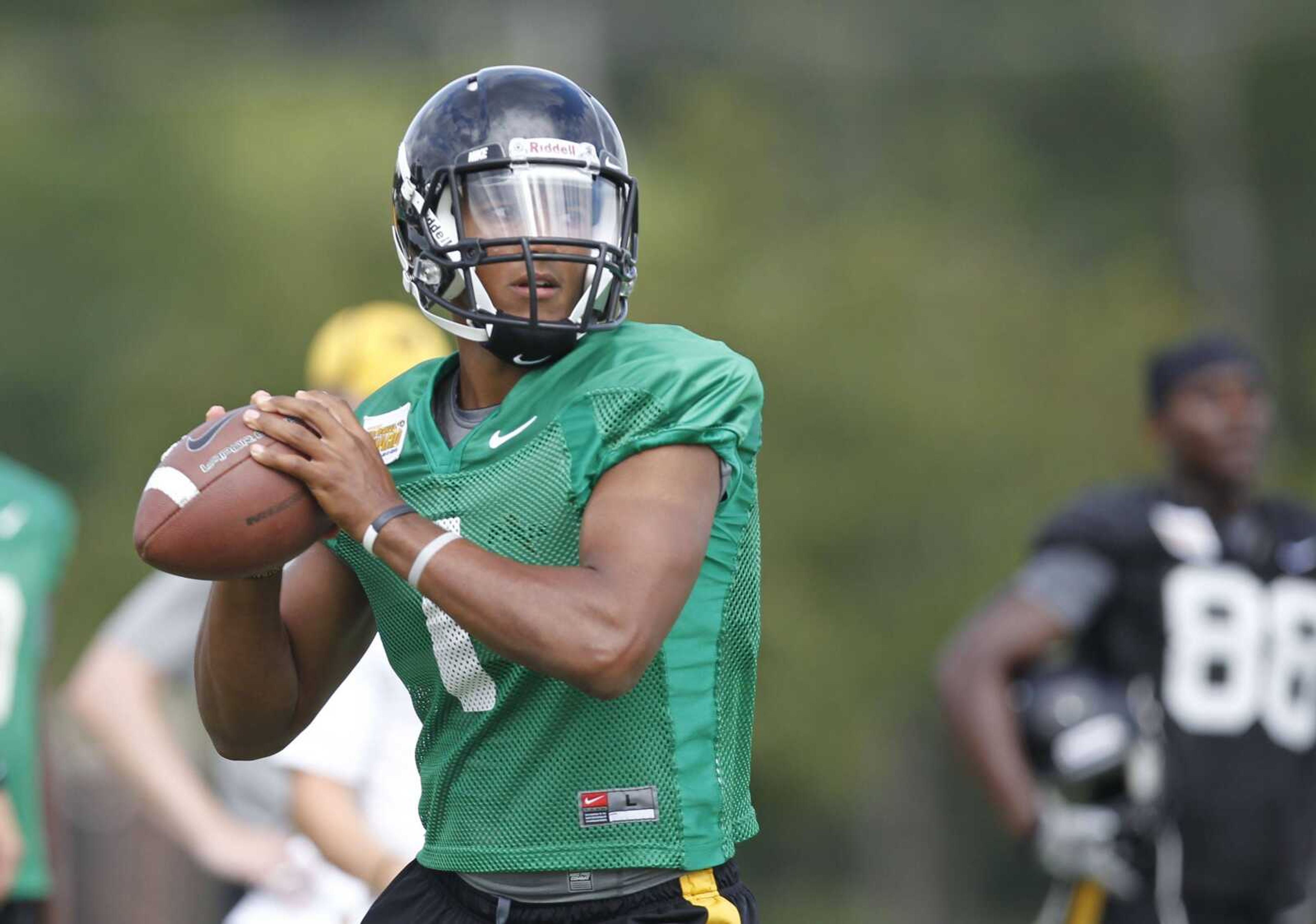 FILE - In this Aug. 15, 2011 file phot, Missouri quarterback James Franklin drops back to pass during NCAA college football practice in Columbia, Mo. Blaine Gabbert made a big splash in his debut two years ago, leading a rout over Illinois. So did the two quarterbacks before him, Chase Daniel and Brad Smith. The 21st-ranked Tigers don't want to put too much pressure on the new guy to do it, too. (AP Photo/Jeff Roberson, File)