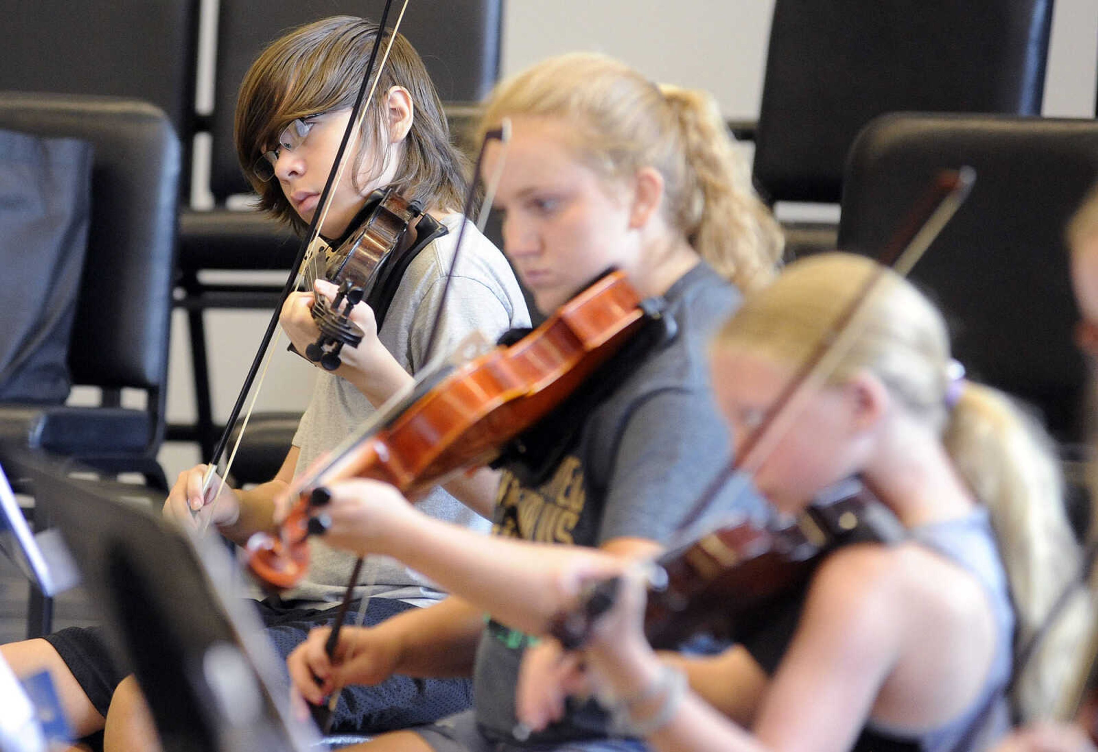 LAURA SIMON ~ lsimon@semissourian.com

Gabe Bengtson, left, Sara Williams, center, and Kami Eubank play their fiddles during Southeast Missouri State University Music Academy's Exploring American Fiddle Styles class taught by Steve Schaffner at the River Campus on Wednesday, July 20, 2016.