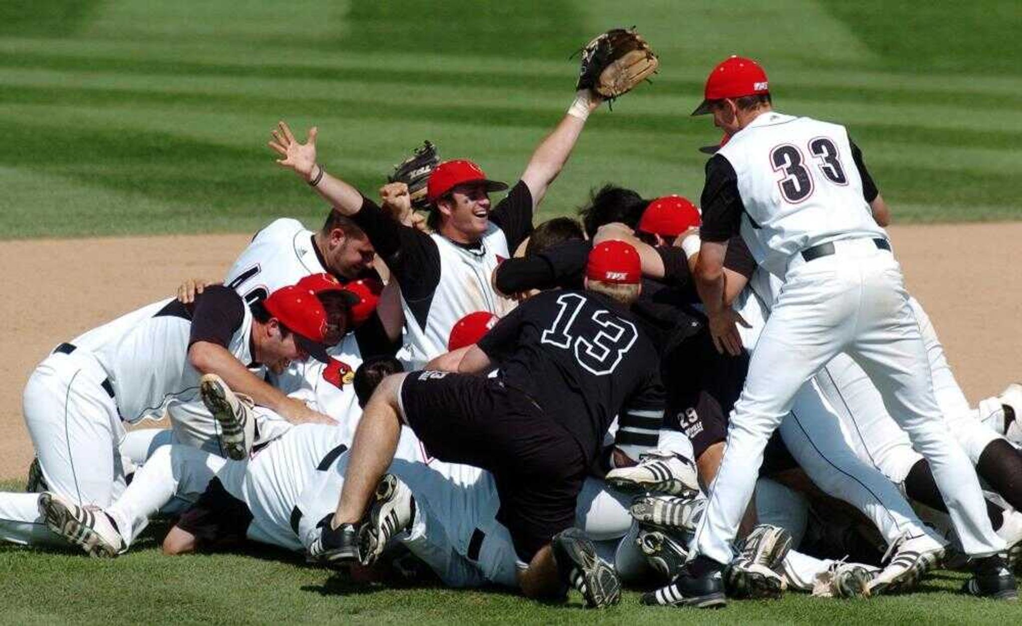 Louisville's Logan Johnson, center, raises his arms in victory Monday, June 4, 2007, after they defeated Missouri 16-6 in their NCAA Regional baseball championship game in Columbia, Mo. (AP Photo/L.G. Patterson)