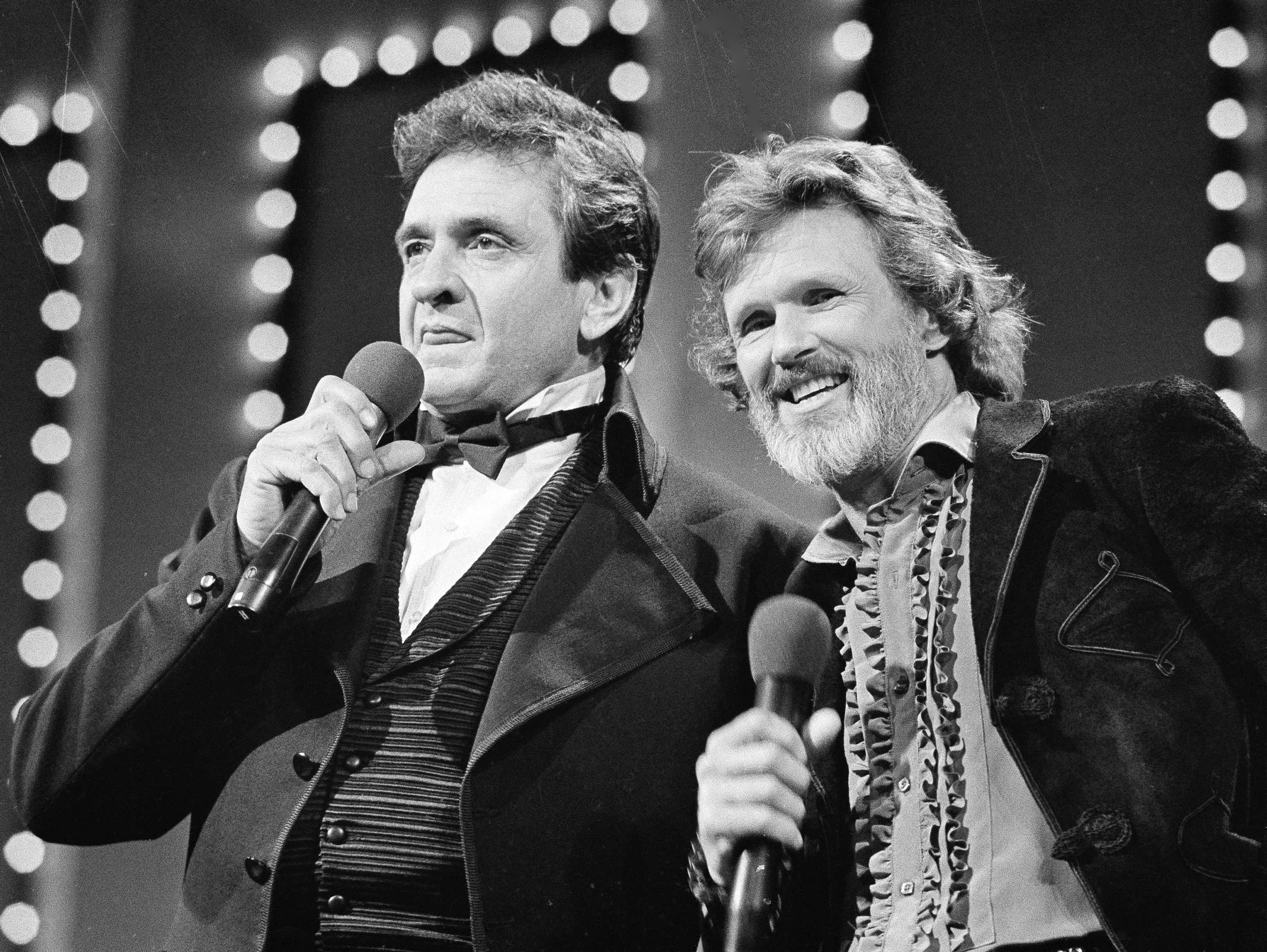 FILE - Country stars Johnny Cash, left and Kris Kristofferson sing during the Country Music Awards in Nashville, Tenn., Oct. 1983. Kristofferson, a Rhodes scholar with a deft writing style and rough charisma who became a country music superstar and A-list Hollywood actor, has died Saturday, Sept. 28, 2024. (AP Photo, File)