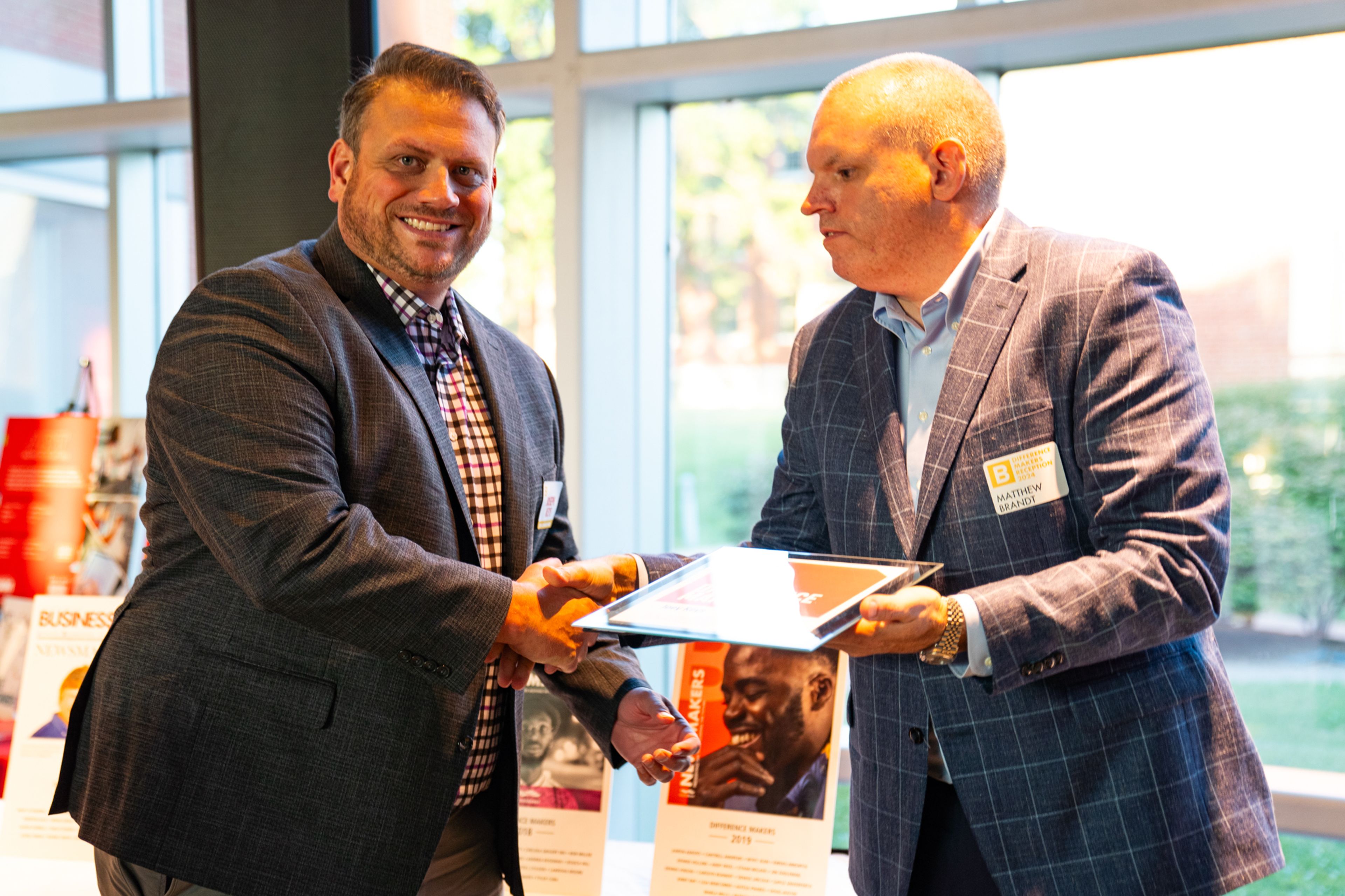 Joey Keys receives a plaque from Saint Francis Healthcare System’s Matthew Brandt recognizing him as a 2024 Difference Maker at their reception at Southeast Missouri State University’s River Campus. The Difference Maker’s reception was presented by B Magazine on Thursday, Sept. 6.