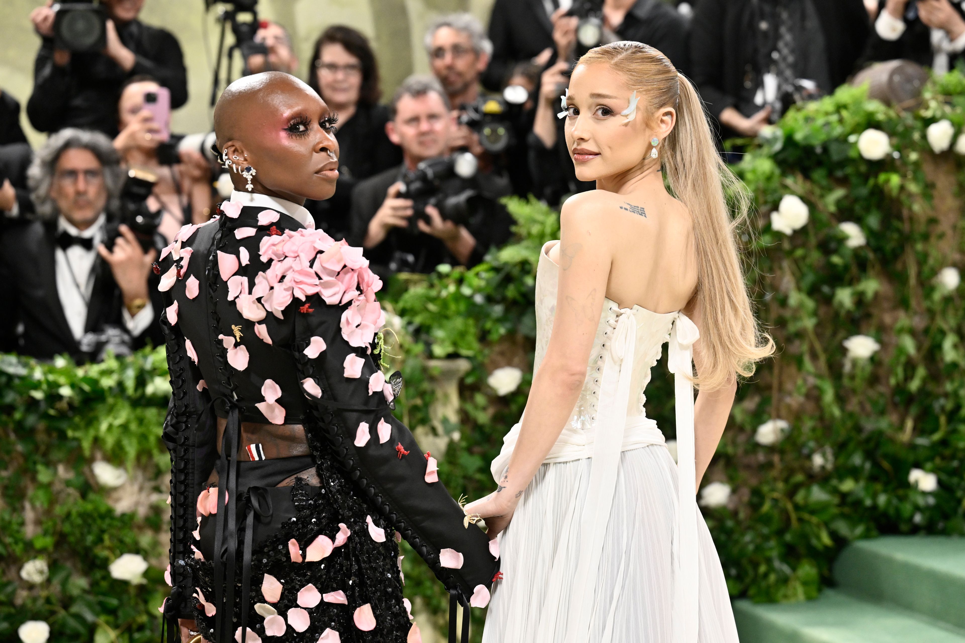 FILE - Cynthia Erivo, left, and Ariana Grande attend The Metropolitan Museum of Art's Costume Institute benefit gala celebrating the opening of the "Sleeping Beauties: Reawakening Fashion" exhibition on Monday, May 6, 2024, in New York. In “Wicked,” Elphaba and Glinda travel from Shiz University to the Emerald City on a glistening green train to meet the wizard. In real life, Cynthia Erivo and Ariana Grande have traveled much farther and wider and longer and on airplanes to promote their hotly anticipated film. (Photo by Evan Agostini/Invision/AP, File)