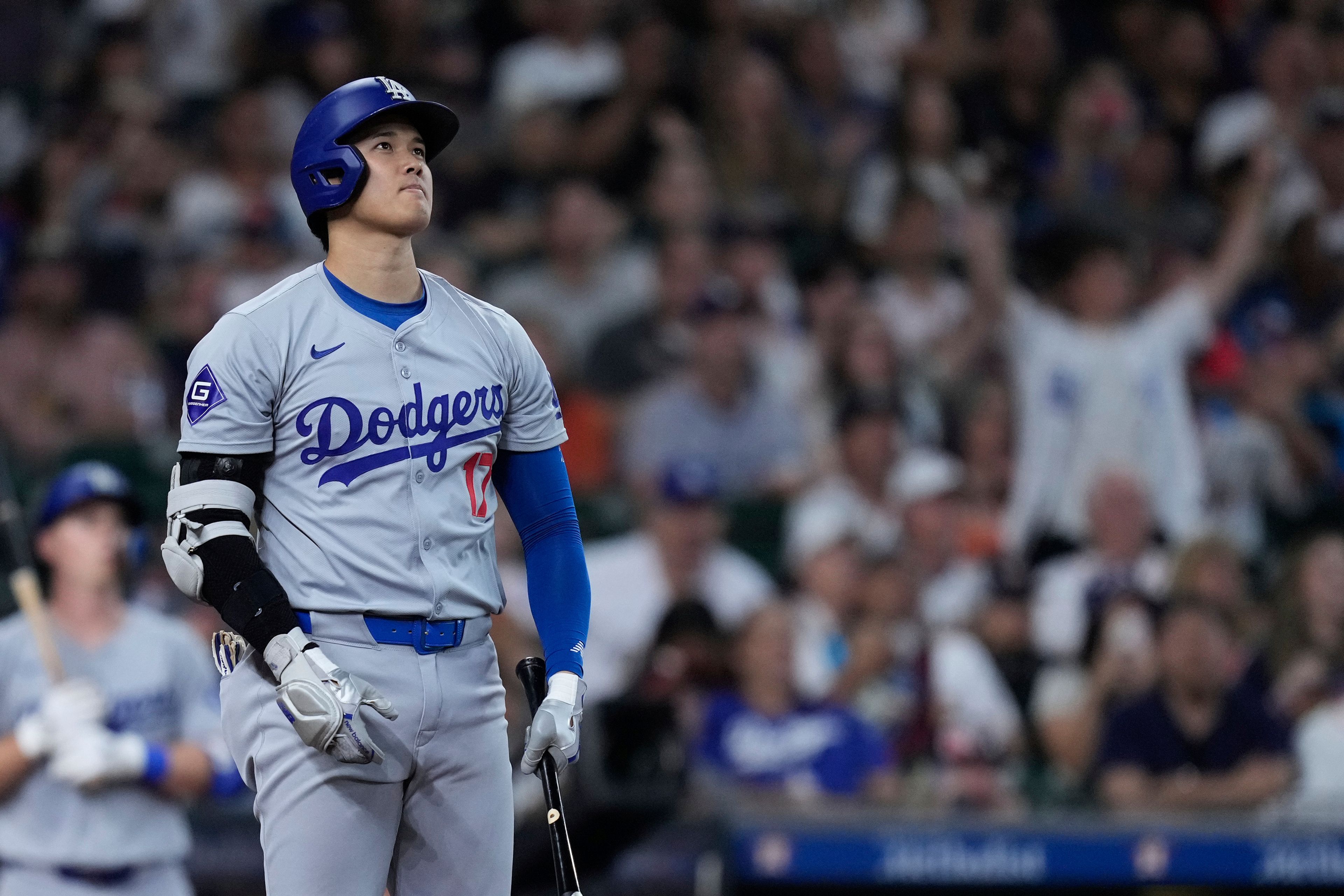 Los Angeles Dodgers designated hitter Shohei Ohtani watches his solo home run leave the park during the third inning of a baseball game against the Houston Astros, Saturday, July 27, 2024, in Houston. (AP Photo/Kevin M. Cox)