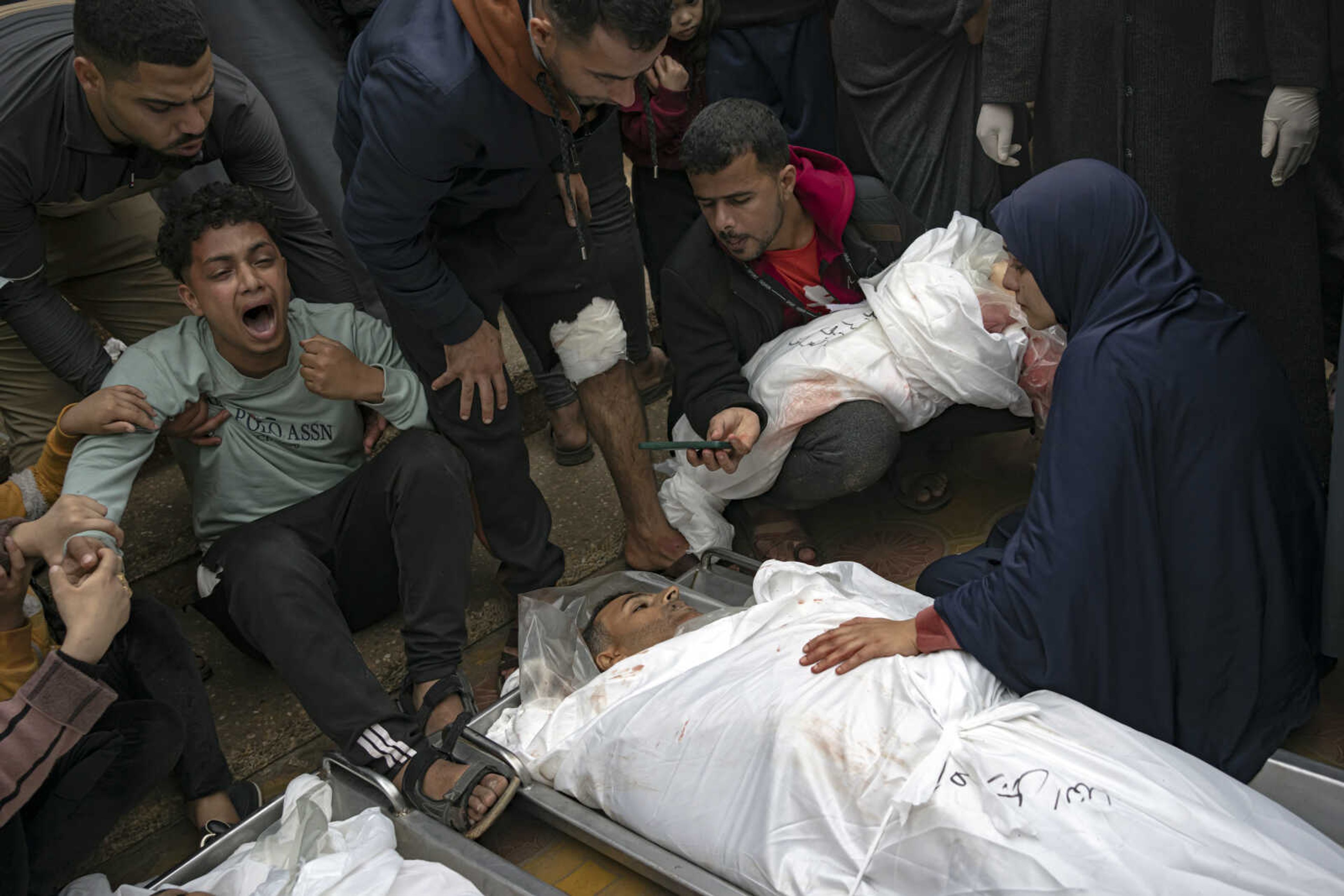 Palestinians mourn their relatives killed in an Israeli army bombardment of the Gaza Strip, outside the hospital Tuesday in Khan Younis.