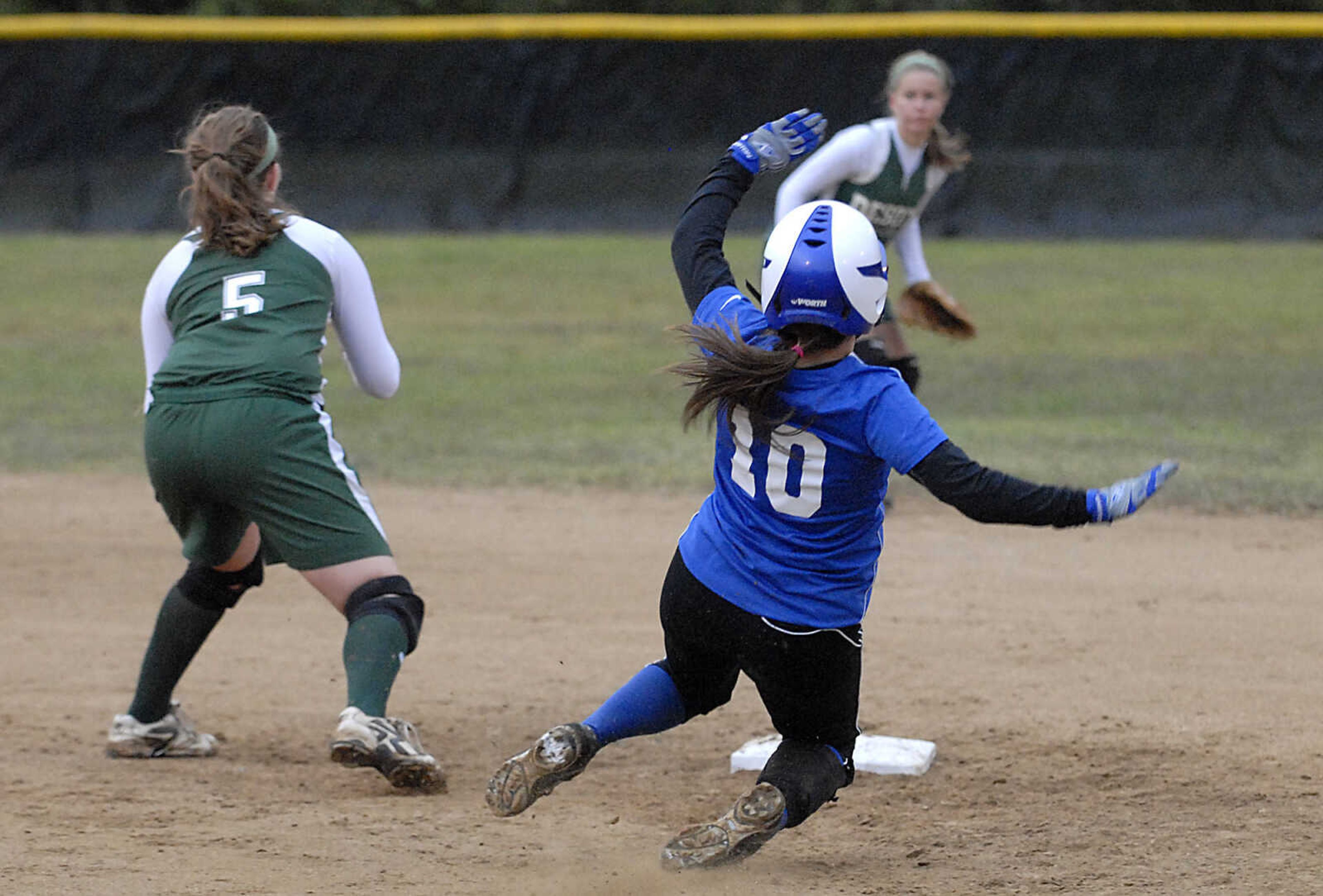 KIT DOYLE ~ kdoyle@semissourian.com
Notre Dame senior Mallory Siebert safely slides into second base with a double as DeSoto's Hailey Brown covers Thursday, October 15, 2009, in Poplar Bluff.