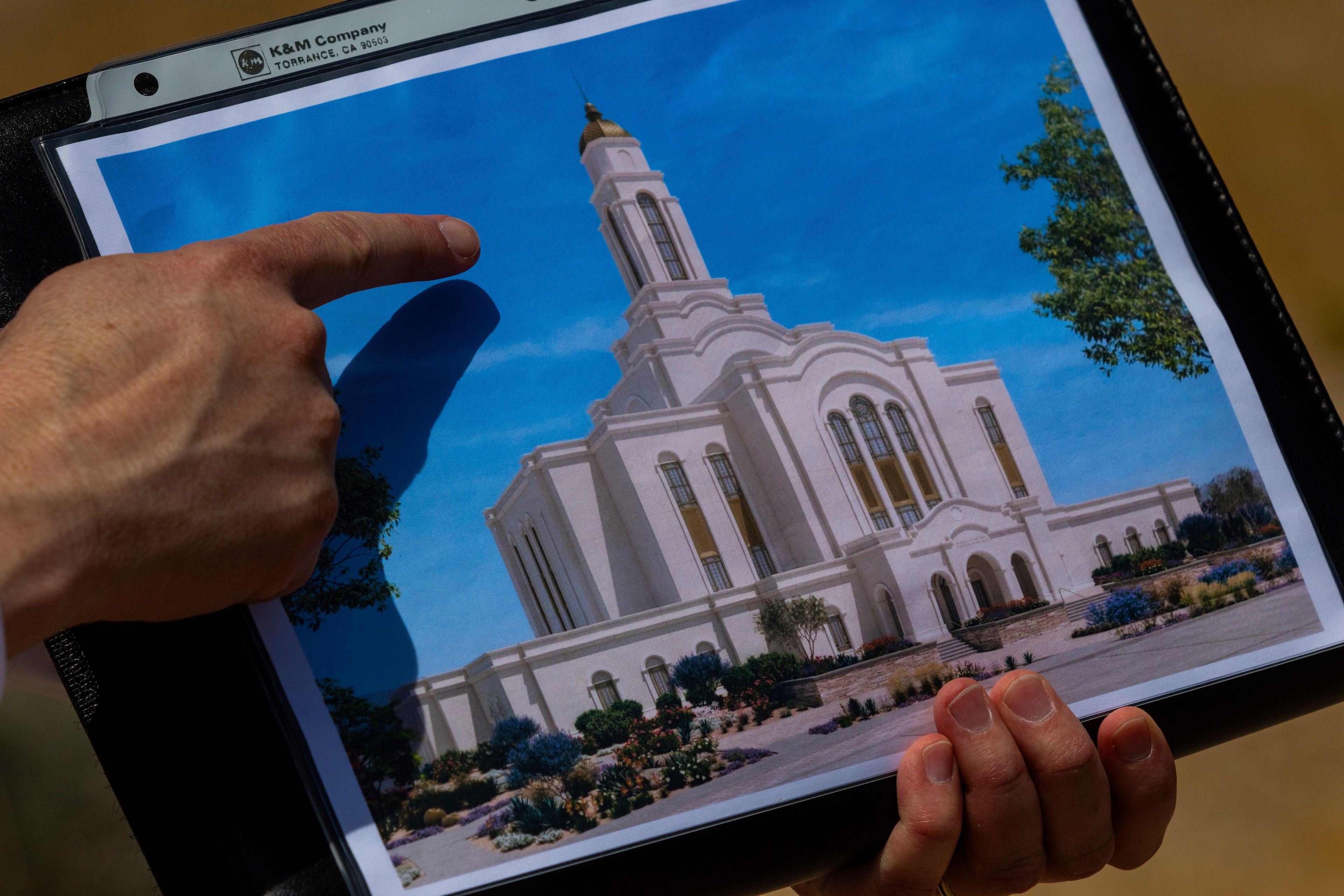 Bud Stoddard, a regional church leader, holds a rendering of the temple planned by The Church of Jesus Christ of Latter-day Saints at a site near Las Vegas, May 16, 2024. (AP Photo/Ty ONeil)