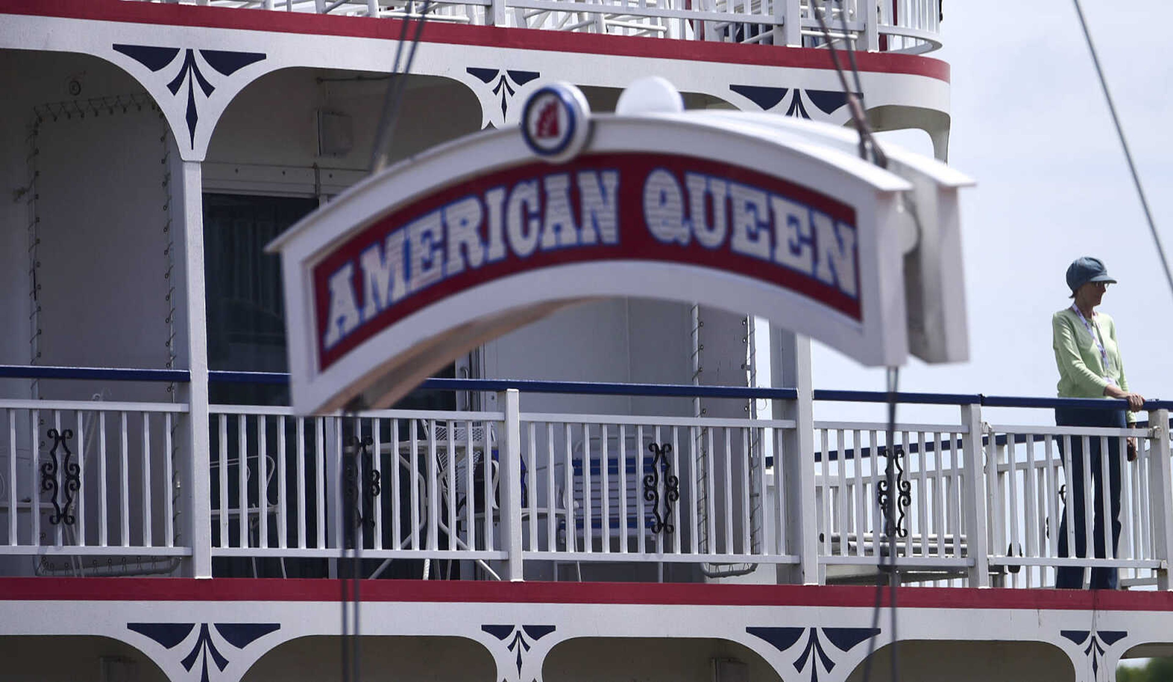 A passenger aboard the Queen of the Mississippi watches as the American Queen departs Riverfront Park on Wednesday, Aug. 23, 2017, in downtown Cape Girardeau.