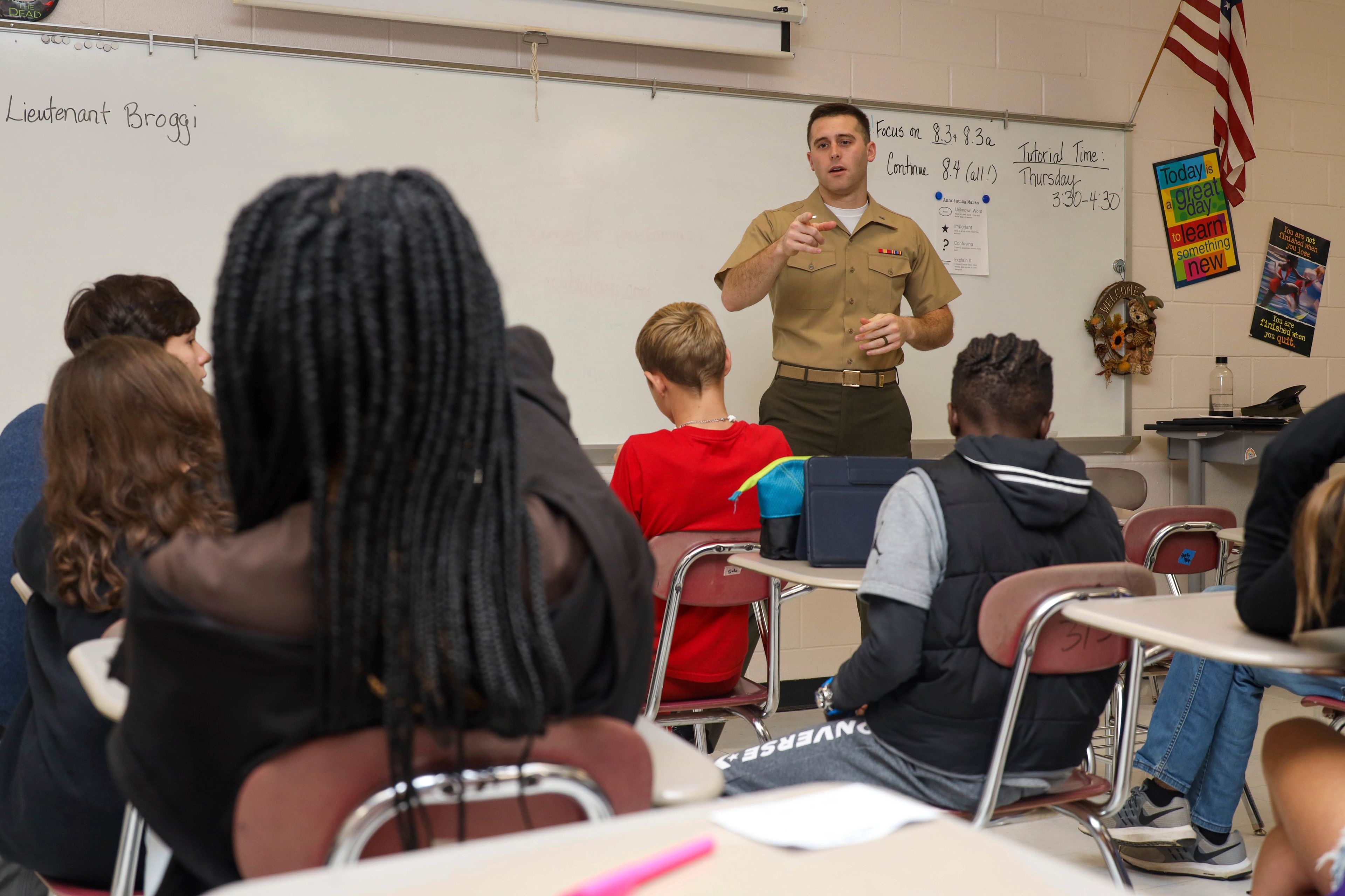 Then-1st Lt. Jameson Broggi, the deputy staff judge advocate with Marine Corps Air Station (MCAS) Cherry Point, answers questions from students about a career in law during its annual eighth grade career day at Tucker Creek Middle School, Havelock, N.C., on Oct. 24, 2022. Broggi, now a captain, has written legislation requiring all public university students to complete a civics class before they can graduate. (Lance Cpl. Symira Bostic/U.S. Marine Corps via AP)