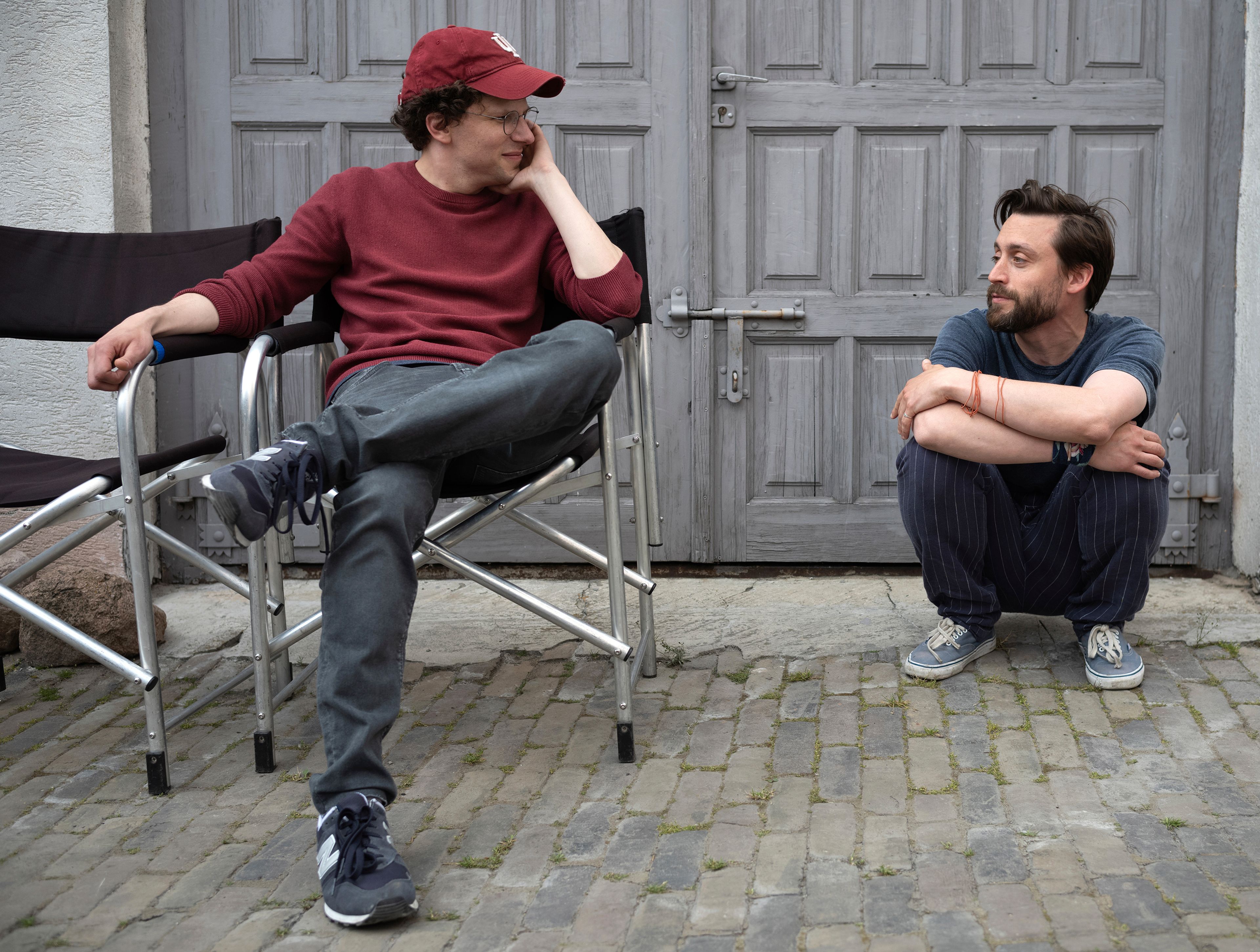 This image released by Searchlight Pictures shows Kieran Culkin, right, and Jesse Eisenberg on the set of "A Real Pain." (Searchlight Pictures via AP)