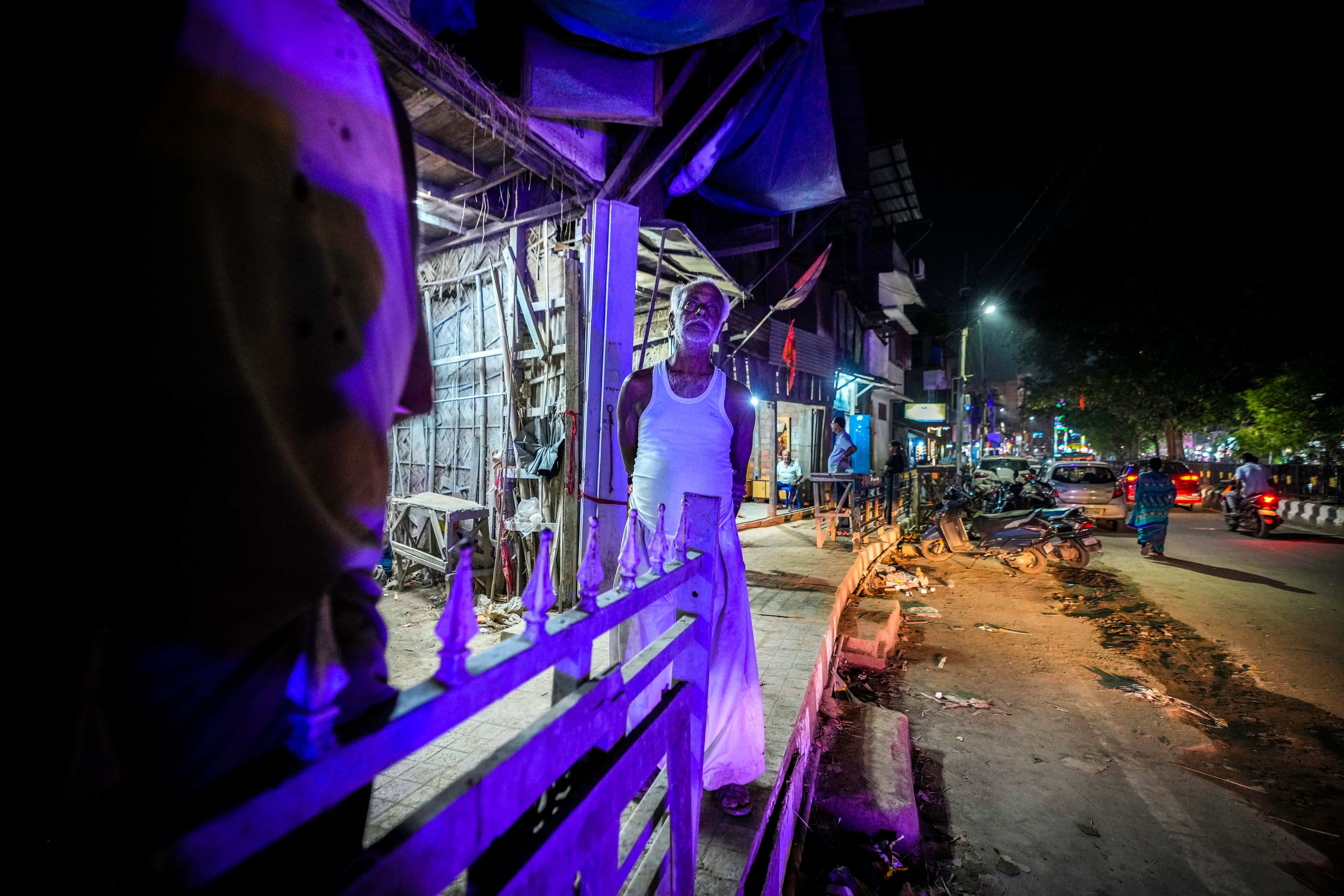 Ratan Paul, 70, looks on after last of the mud idols of the Hindu goddess Durga and other deities were collected by customers from his workshop during the Durga Puja festival in Guwahati, India, Tuesday, Oct. 8, 2024. (AP Photo/Anupam Nath)