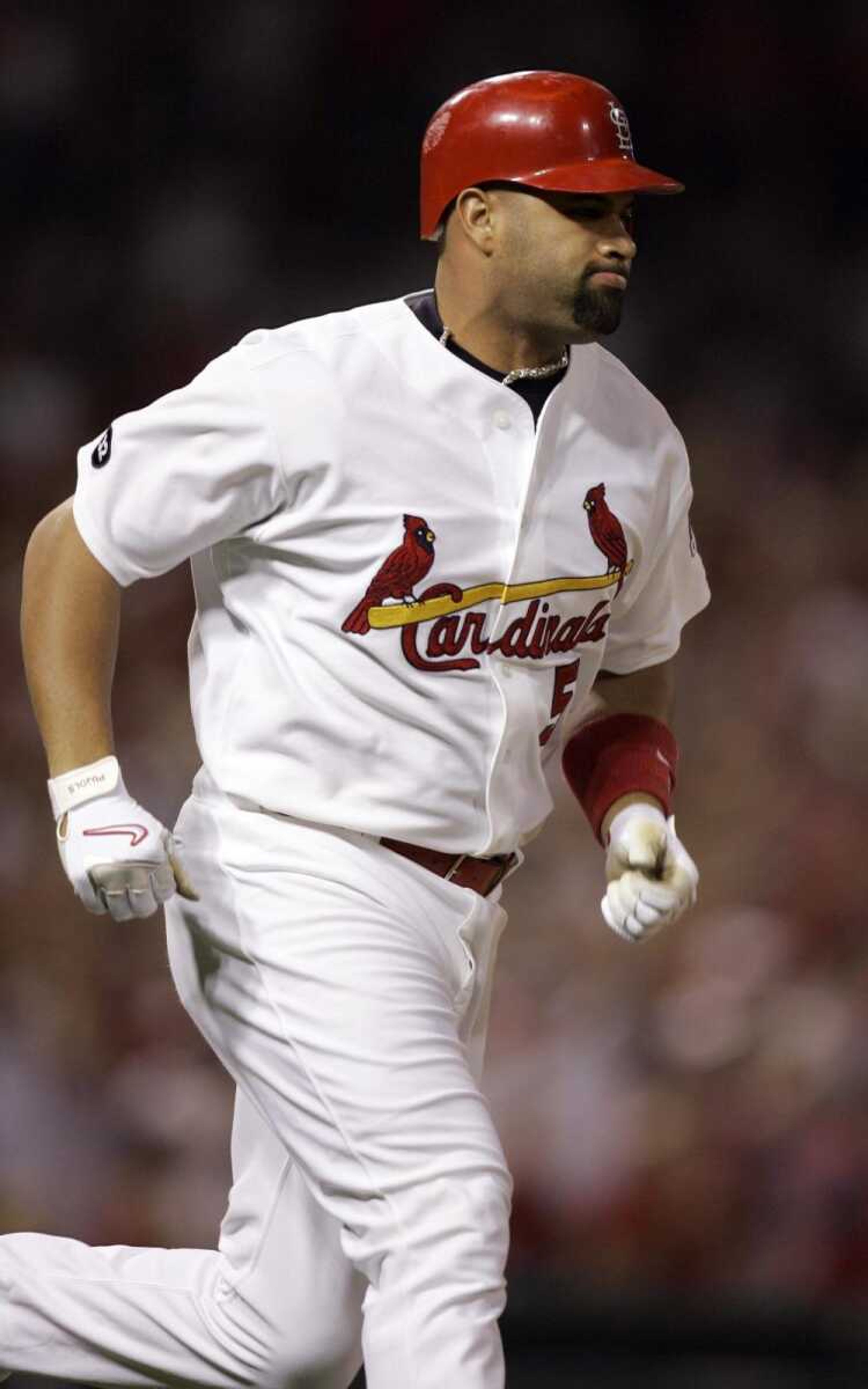 St. Louis Cardinals' Albert Pujols limps to first base on a two-run single during the seventh inning of a baseball game against the Houston Astros Saturday, Sept. 22, 2007, in St. Louis. Sidelined by a strained left calf muscle and forced into games as a pinch-hitter recently, Pujols is one RBI away from becoming the first player to get 100 RBIs in his first seven seasons. (AP Photo/Jeff Roberson, file)