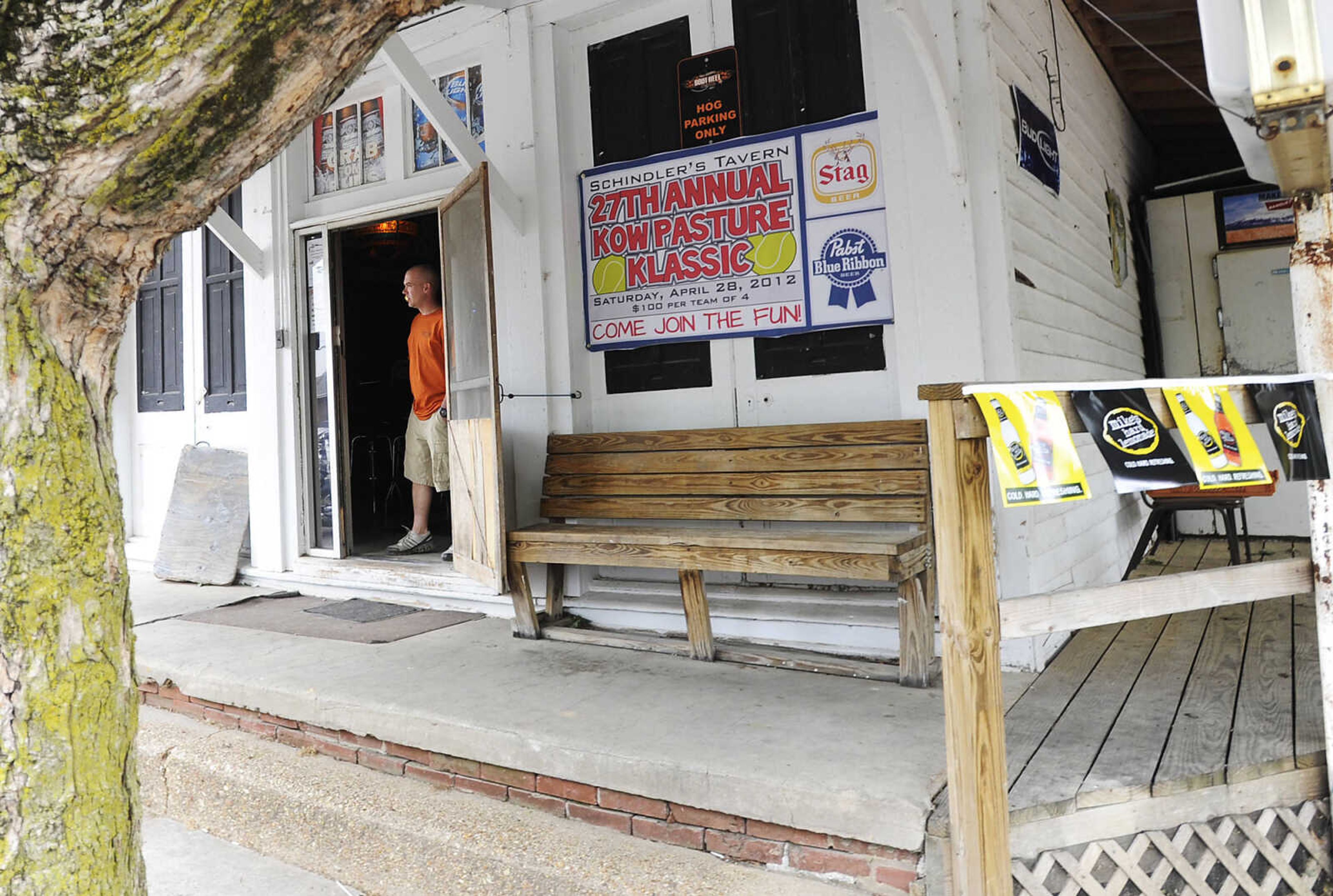 A staff member looks out the front door of Schindler's Tavern in New Hamburg during the Kow Pasture Klassic Saturday, April 28. Teams play a nine-hole course laid out in a pasture behind the tavern using tennis balls and a variety of objects as clubs, including tennis rackets, oars and mallets.