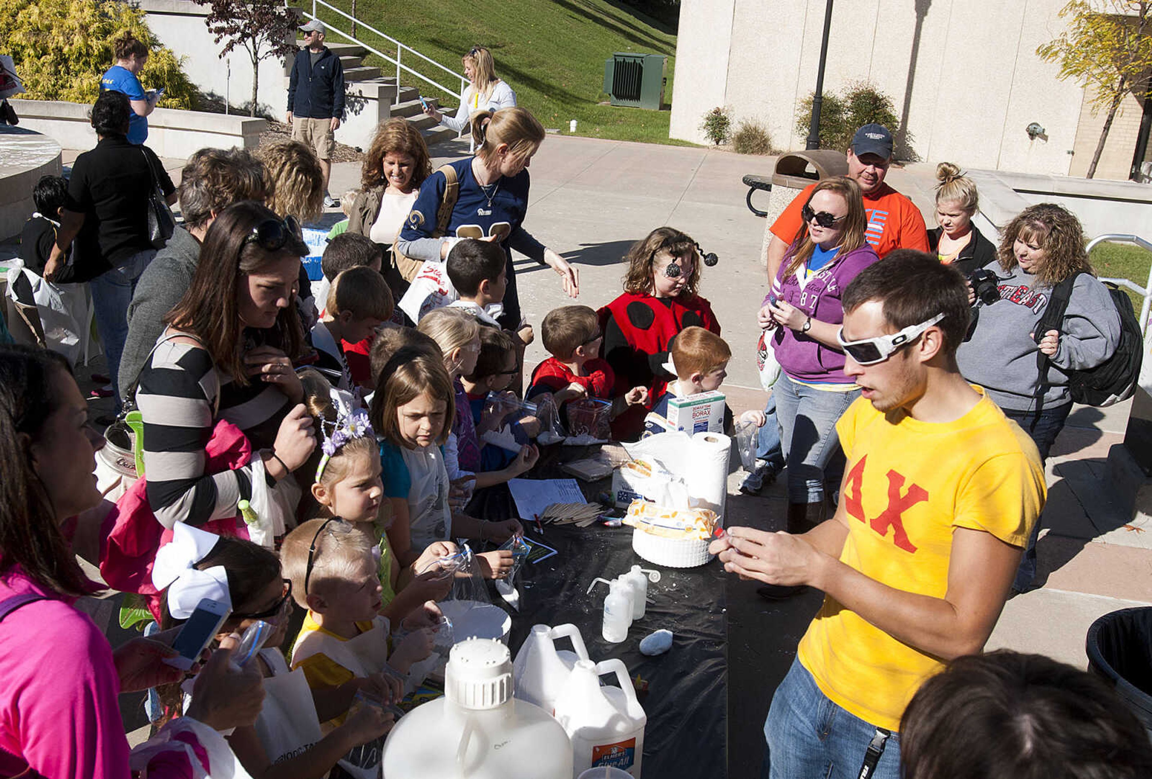 Southeast Missouri State University student Ladislav Stastny shows a group of children how to make slime out of glue and borax with a little food coloring and glitter during the fifth annual Halloween Science Night Sunday, Oct. 20, on the campus of Southeast Missouri State University. The event featured 21 stations, such as the "Scream Room," "Creepy Creatures," or the "Mucus Lab," each with a different Halloween themed science activity. The night is funded by a grant from the Missouri Foundation for Health in partnership with Southeast's College of Science, Technology and Agriculture and Extended and Continuing Education.