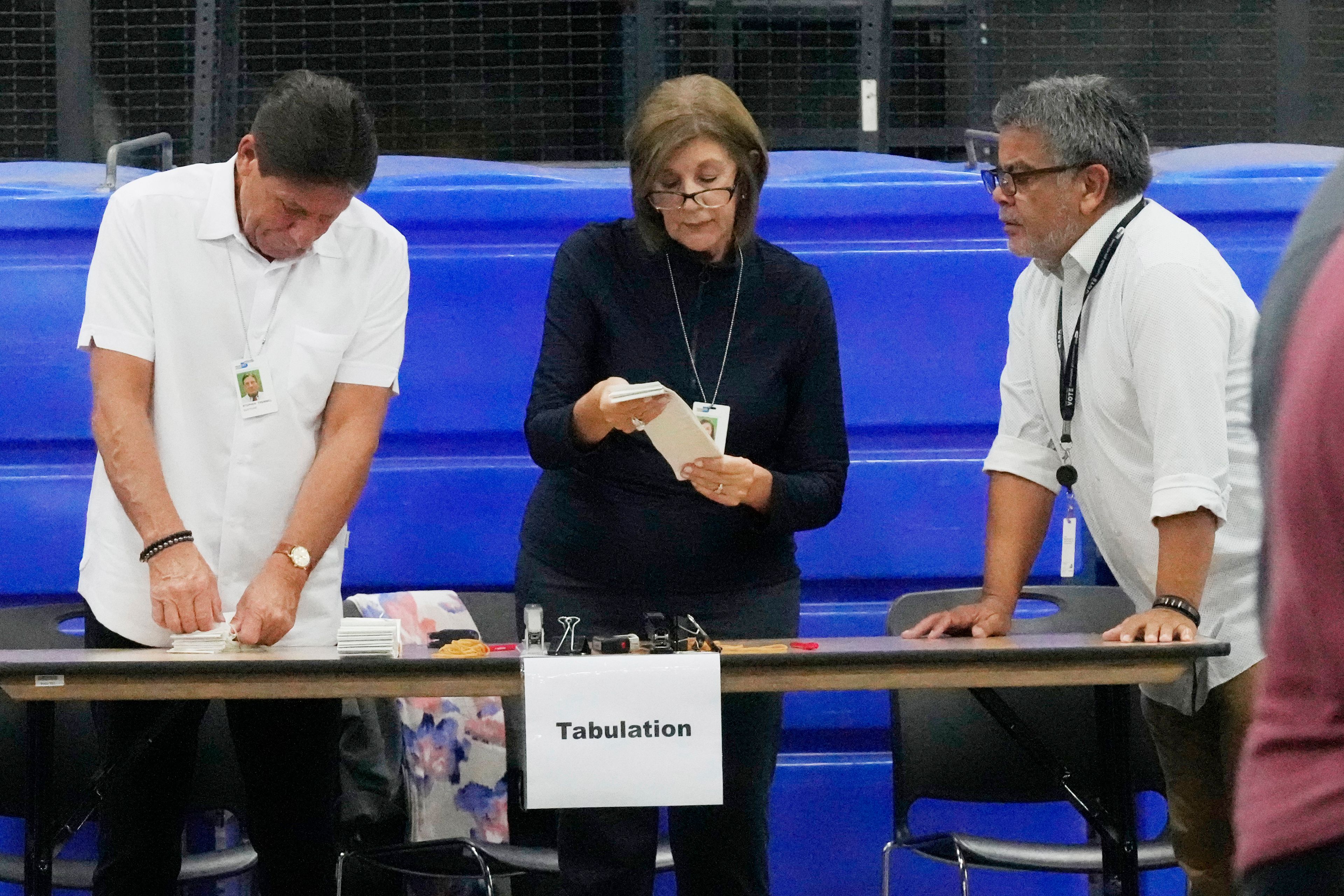 Employees at the Miami-Dade County Supervisor of Elections finish a comprehensive test on the voting machines that will be used in the upcoming general election, Wednesday, Oct. 16, 2024, in Doral, Fla. (AP Photo/Marta Lavandier)