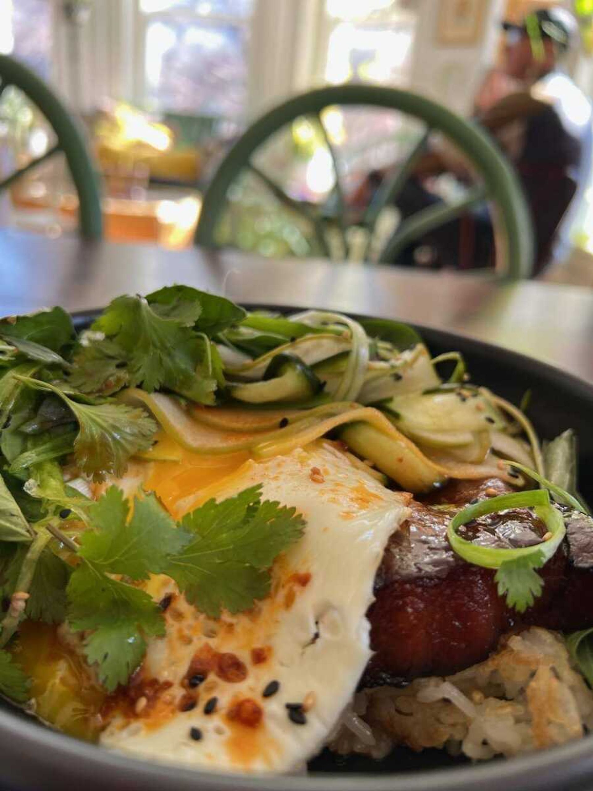 The pork belly eggs benedict was comprised of marinated pork belly, crispy sushi rice, egg, gochuchang hollandaise, pickled cucumber and apple thai basil cilantro with scallions.