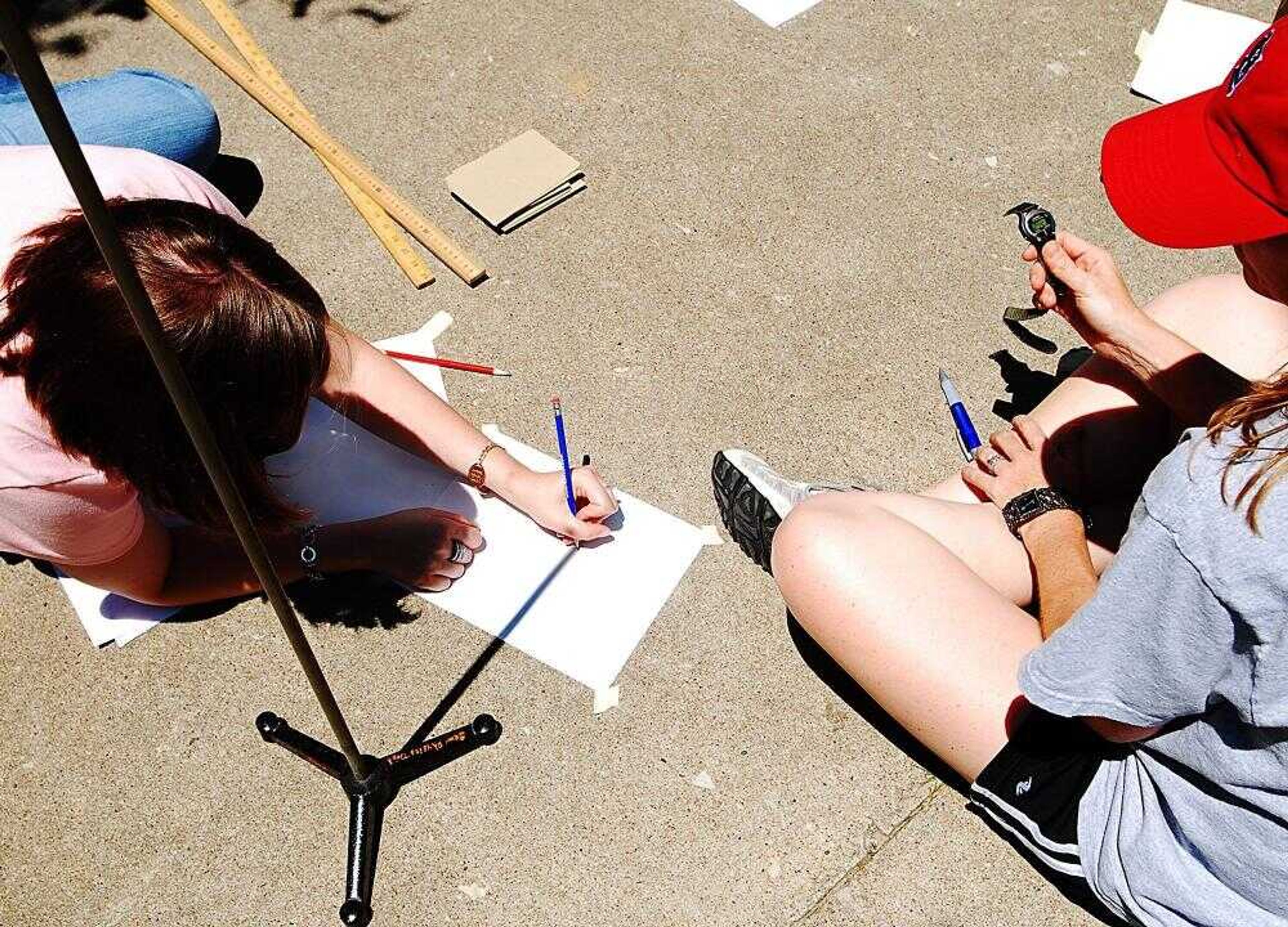 Christina Brands, a North Pemiscot Junior High teacher, marked the length of the shadow cast by a pole every three minutes as timed by Amy Kimbrell, a teacher from Crystal City, Mo.,  High School. The group was using shadows to determine the circumference of the Earth.<br>AARON EISENHAUER <br>aeisenhauer@semissourian.com