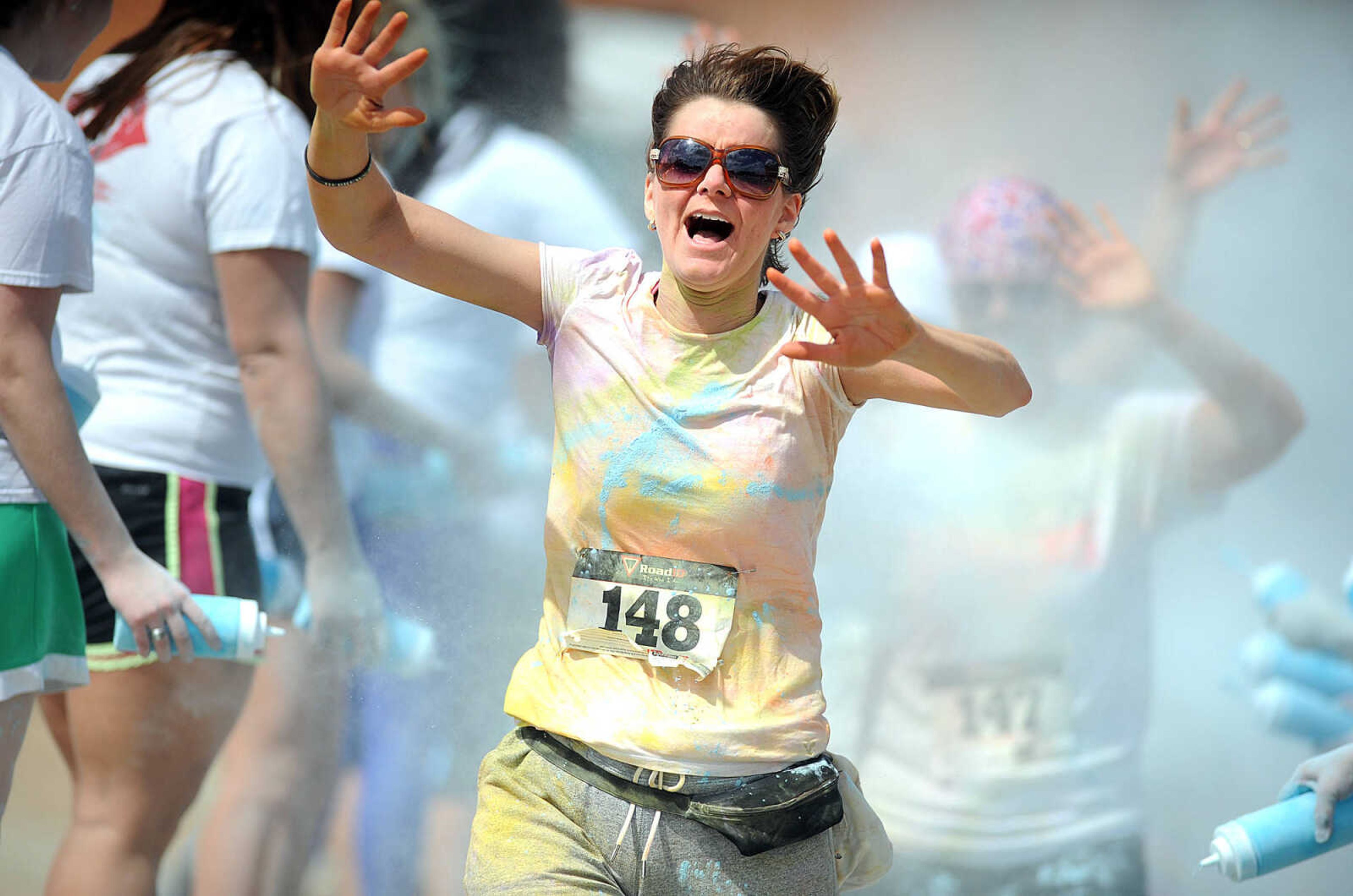 LAURA SIMON ~ lsimon@semissourian.com

Participants in the Color Me Cape 5K are sprayed with blue powder at the final color station on Main Street, Saturday, April 12, 2014, in Cape Girardeau.