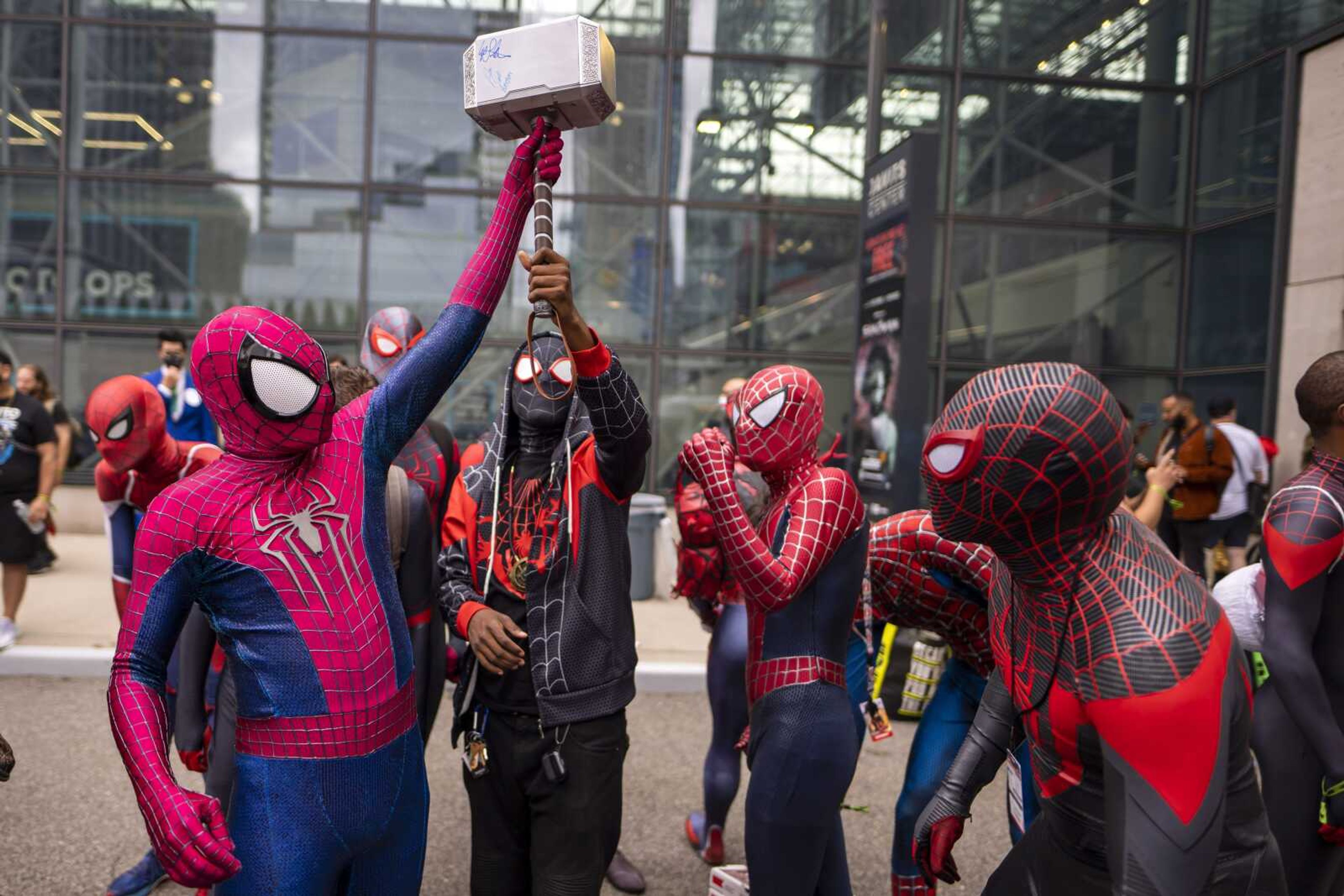 Attendees dressed as versions of Spider-Man gather during New York Comic Con at the Jacob K. Javits Convention Center on Oct. 9 in New York. After spending one weekend in second place, "Spider-Man: No Way Home" proved it still had some fight left. Sony's superhero juggernaut swung back to first place in its sixth weekend in theaters and became the sixth highest grossing film of all time, globally, according to studio estimates Sunday.